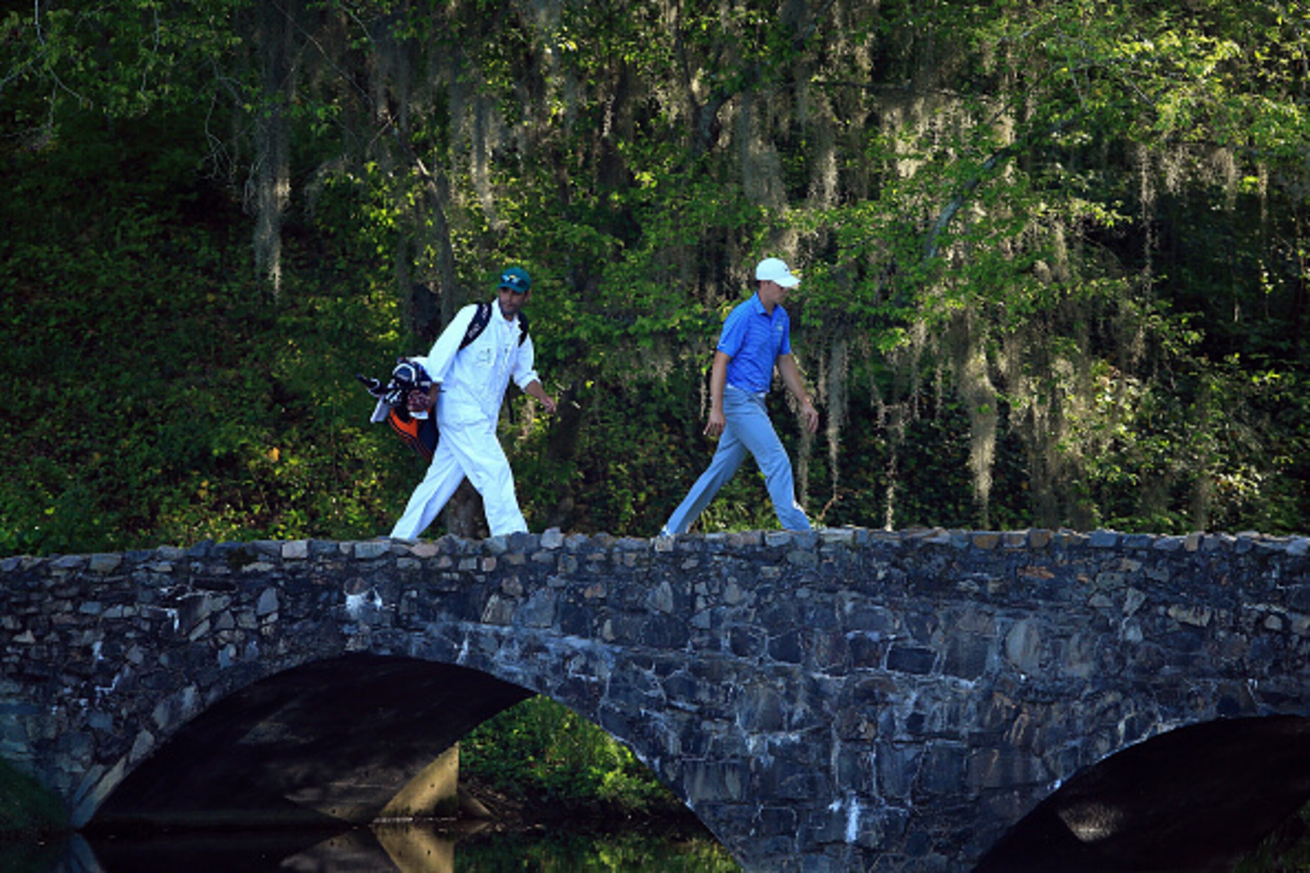 AUGUSTA, GA - APRIL 11:  Jordan Spieth of the United States and his caddie Michael Greller walk over the Nelson Bridge on the 13th hole during the third round of the 2015 Masters Tournament at Augusta National Golf Club on April 11, 2015 in Augusta, Georg