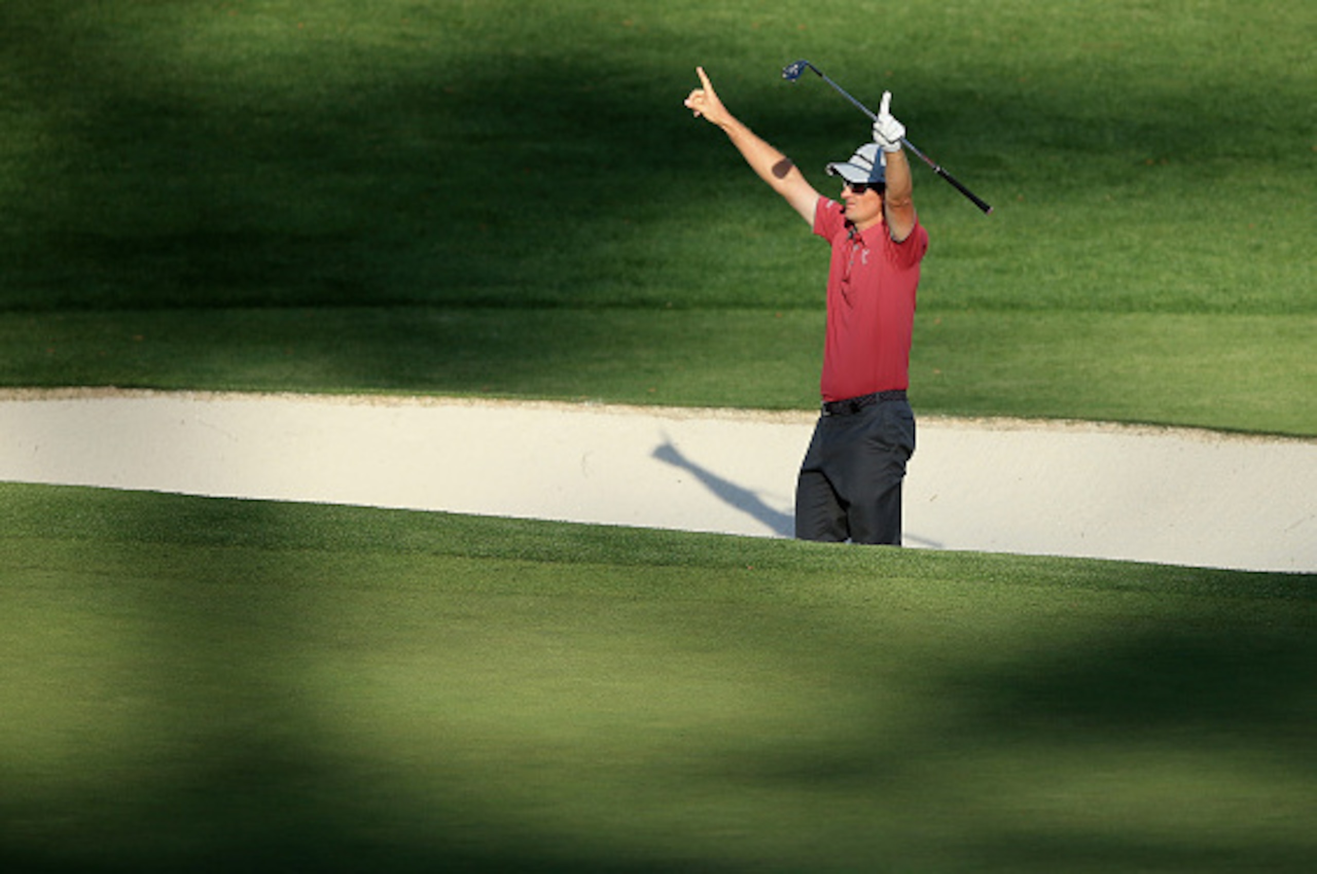 AUGUSTA, GA - APRIL 11:  Justin Rose of England celebrates after holing a bunker shot on the 16th hole during the third round of the 2015 Masters Tournament at Augusta National Golf Club on April 11, 2015 in Augusta, Georgia.  (Photo by David Cannon/Getty