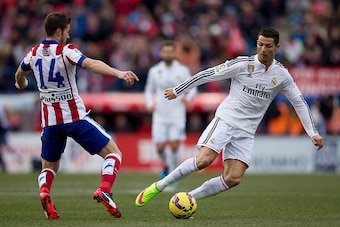 MADRID, SPAIN - FEBRUARY 07: Cristiano Ronaldo (R) of Real Madrid CF competes for the ball with Gabi Fernandez (L) of Atletico de Madrid during the La Liga match between Club Atletico de Madrid and Real Madrid CF at Vicente Calderon Stadium on February 7,