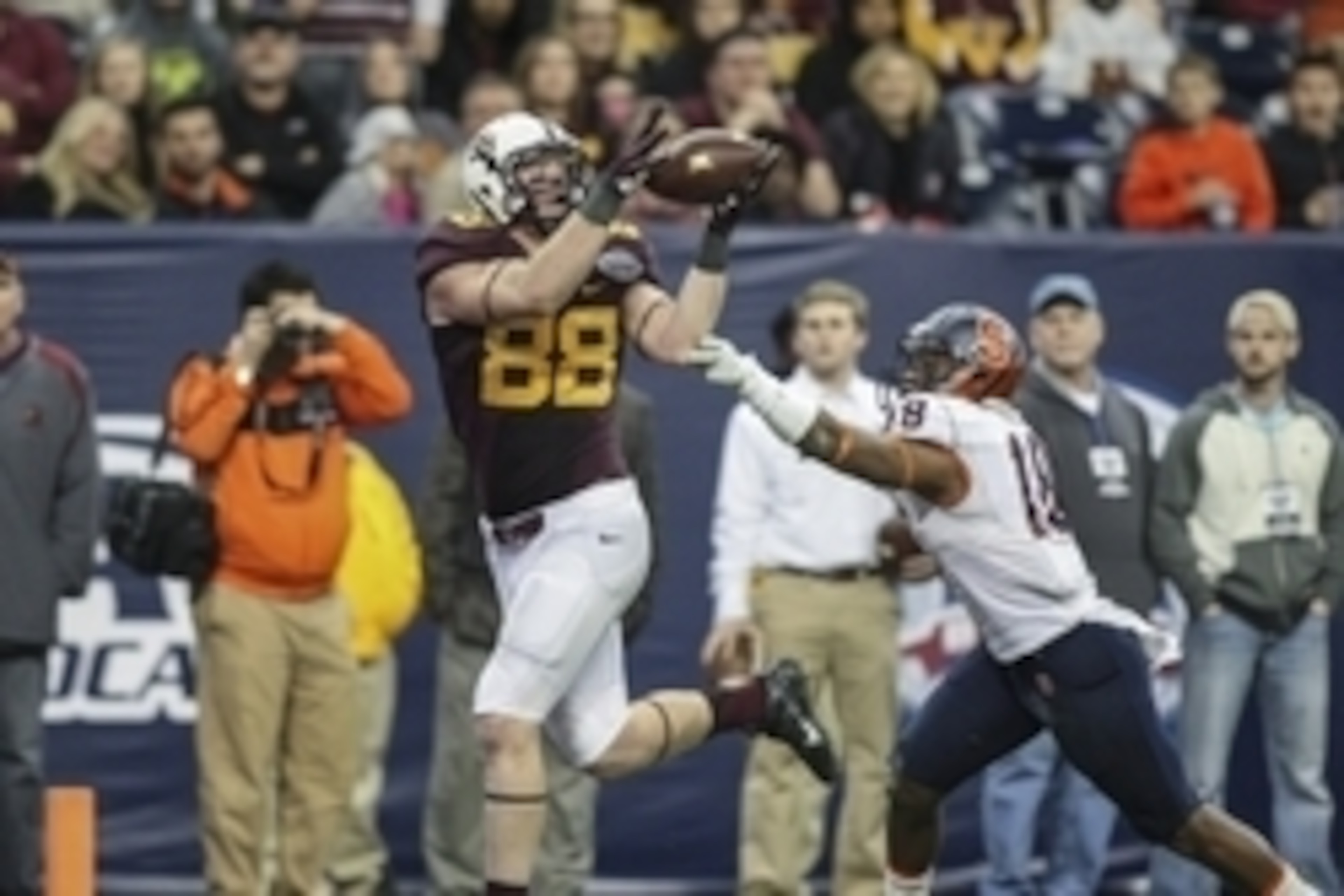 Dec 27, 2013; Houston, TX, USA; Minnesota Golden Gophers tight end Maxx Williams (88) catches a pass for a touchdown during the fourth quarter of the Texas Bowl as Minnesota Golden Gophers linebacker Peter Westerhaus (18) defends at Reliant Stadium . Mand