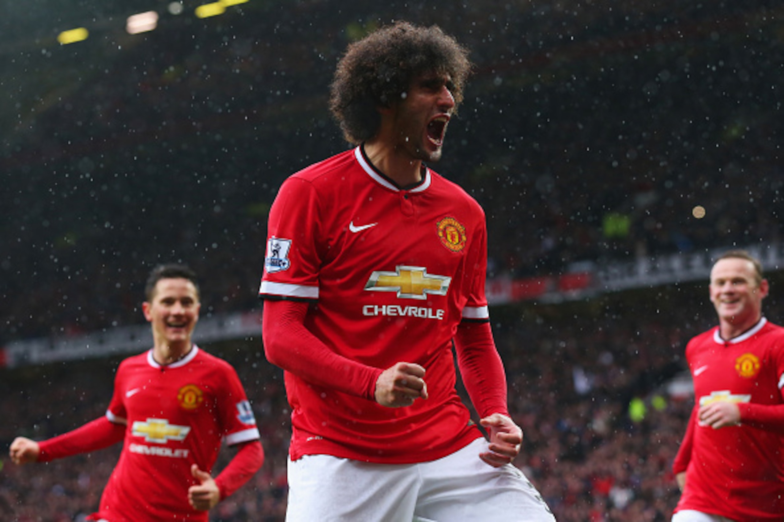 MANCHESTER, ENGLAND - APRIL 12:  Marouane Fellaini of Manchester United (C) celebrates as he scores their second goal with a header during the Barclays Premier League match between Manchester United and Manchester City at Old Trafford on April 12, 2015 in