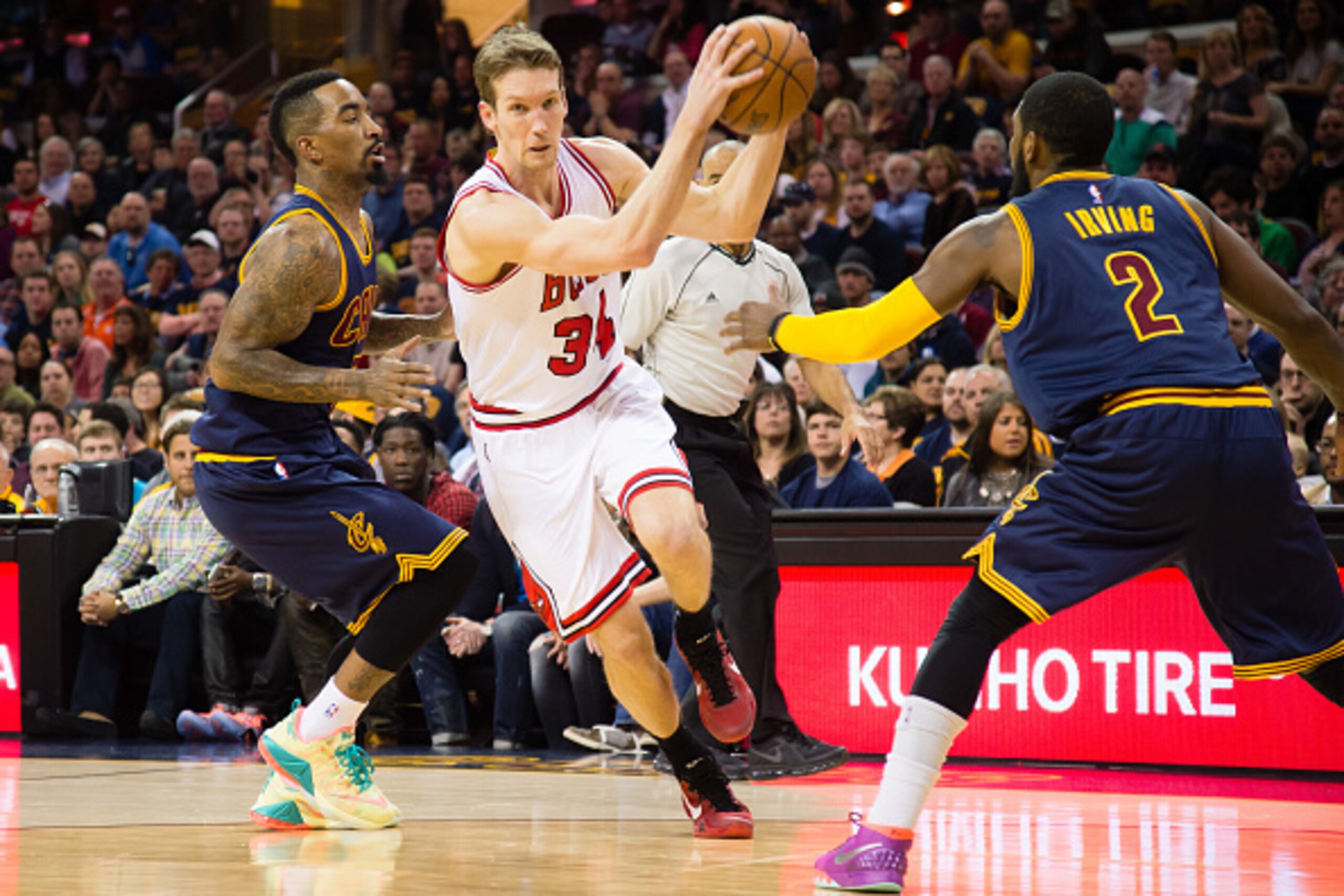 CLEVELAND, OH - APRIL 5: J.R. Smith #5 and Kyrie Irving #2 of the Cleveland Cavaliers try to stop Mike Dunleavy #34 of the Chicago Bulls during the first half at Quicken Loans Arena on April 5, 2015 in Cleveland, Ohio. NOTE TO USER: User expressly acknowl