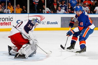 UNIONDALE, NY - APRIL 11: Curtis McElhinney #30 of the Columbus Blue Jackets stops a shot by John Tavares #91 of the New York Islanders at Nassau Veterans Memorial Coliseum on April 11, 2015 in Uniondale, New York.  (Photo by Mike Stobe/NHLI via Getty Ima