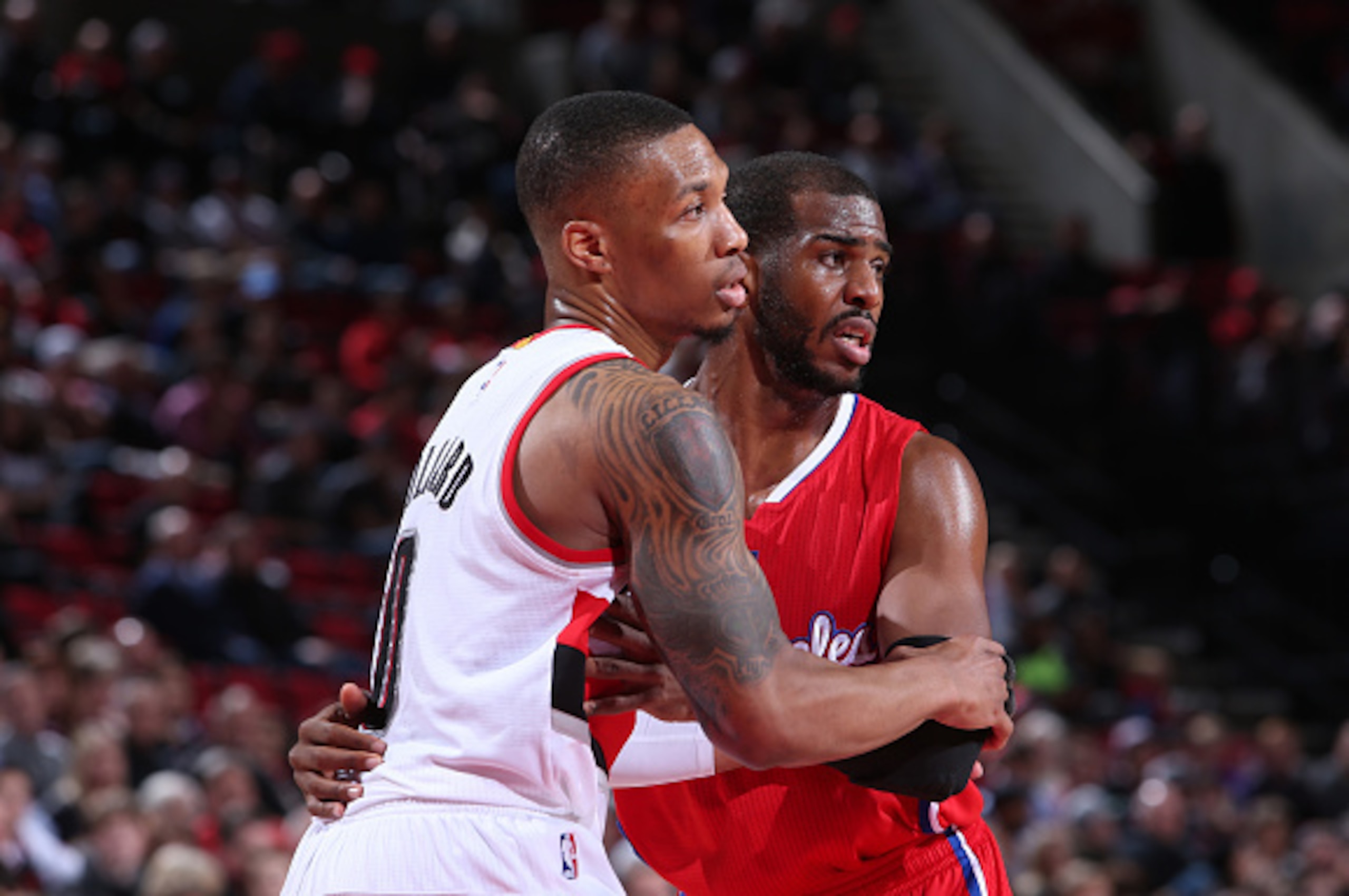 PORTLAND, OR - JANUARY 14:  Chris Paul #3 of the Los Angeles Clippers and Damian Lillard #0 of the Portland Trail Blazers stand on the court on January 14, 2015 at the Moda Center Arena in Portland, Oregon. NOTE TO USER: User expressly acknowledges and ag