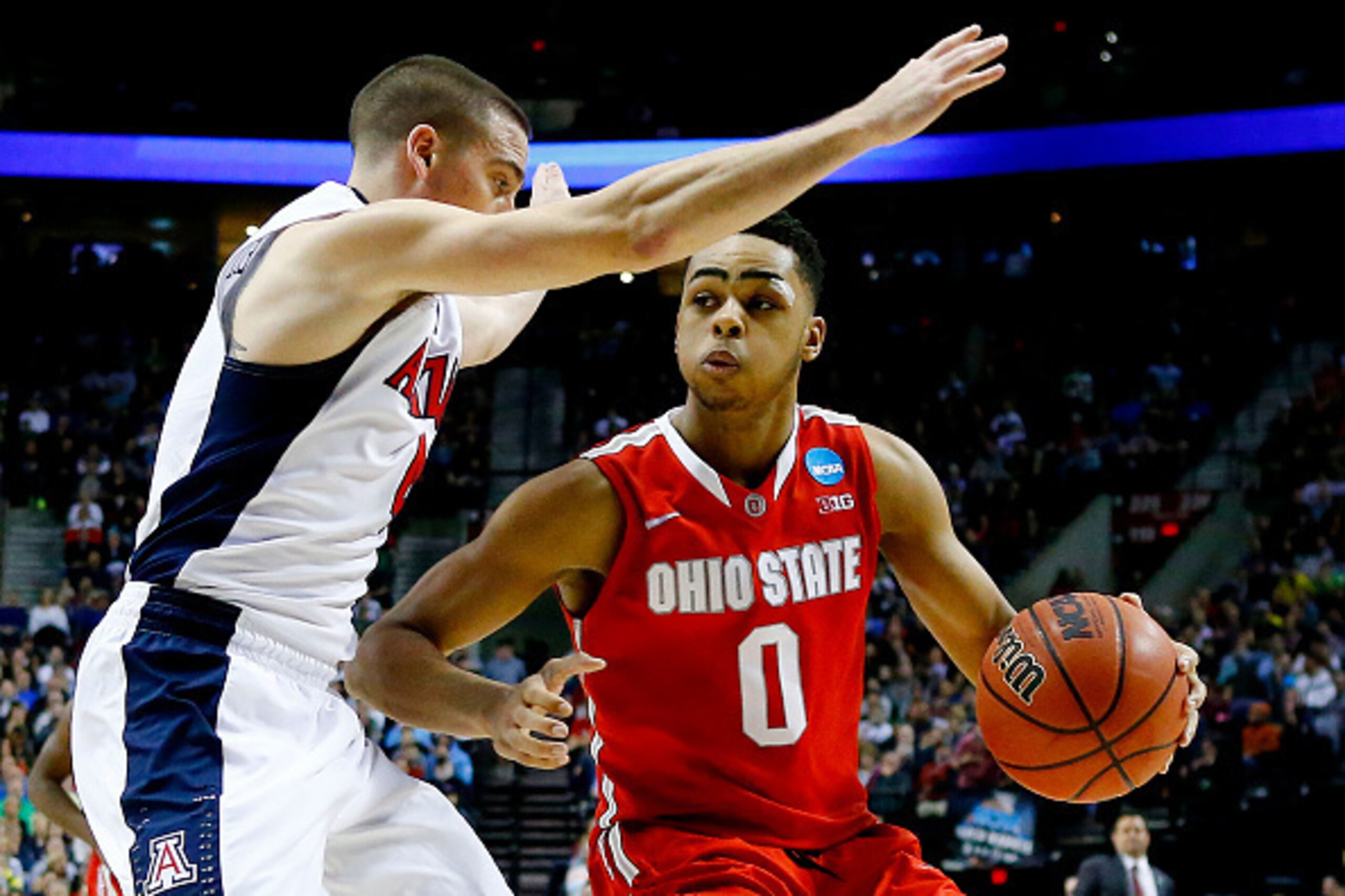PORTLAND, OR - MARCH 21:  D'Angelo Russell #0 of the Ohio State Buckeyes drives against T.J. McConnell #4 of the Arizona Wildcats in the second half during the third round of the 2015 NCAA Men's Basketball Tournament at Moda Center on March 21, 2015 in Po