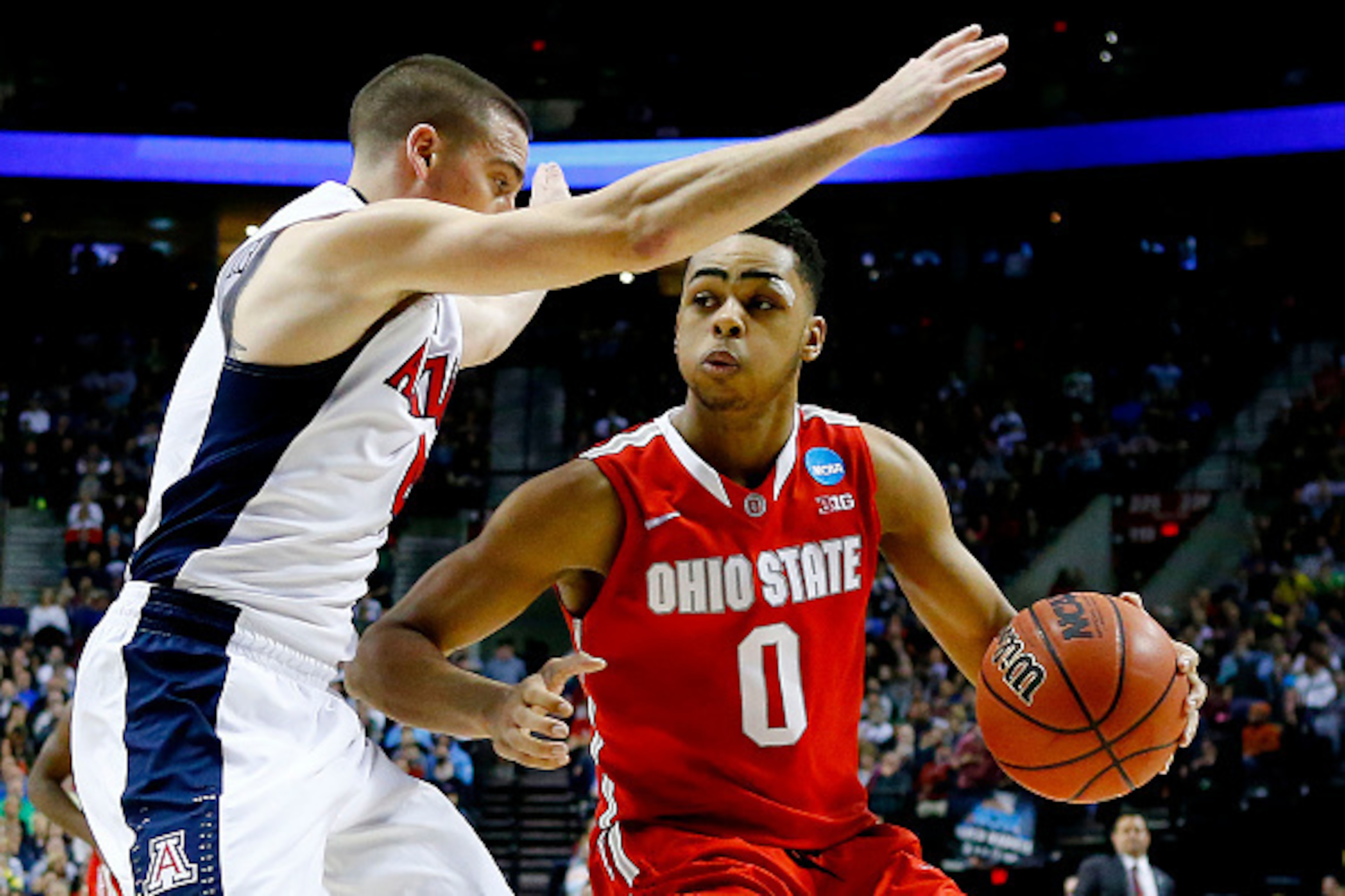 PORTLAND, OR - MARCH 21:  D'Angelo Russell #0 of the Ohio State Buckeyes drives against T.J. McConnell #4 of the Arizona Wildcats in the second half during the third round of the 2015 NCAA Men's Basketball Tournament at Moda Center on March 21, 2015 in Po
