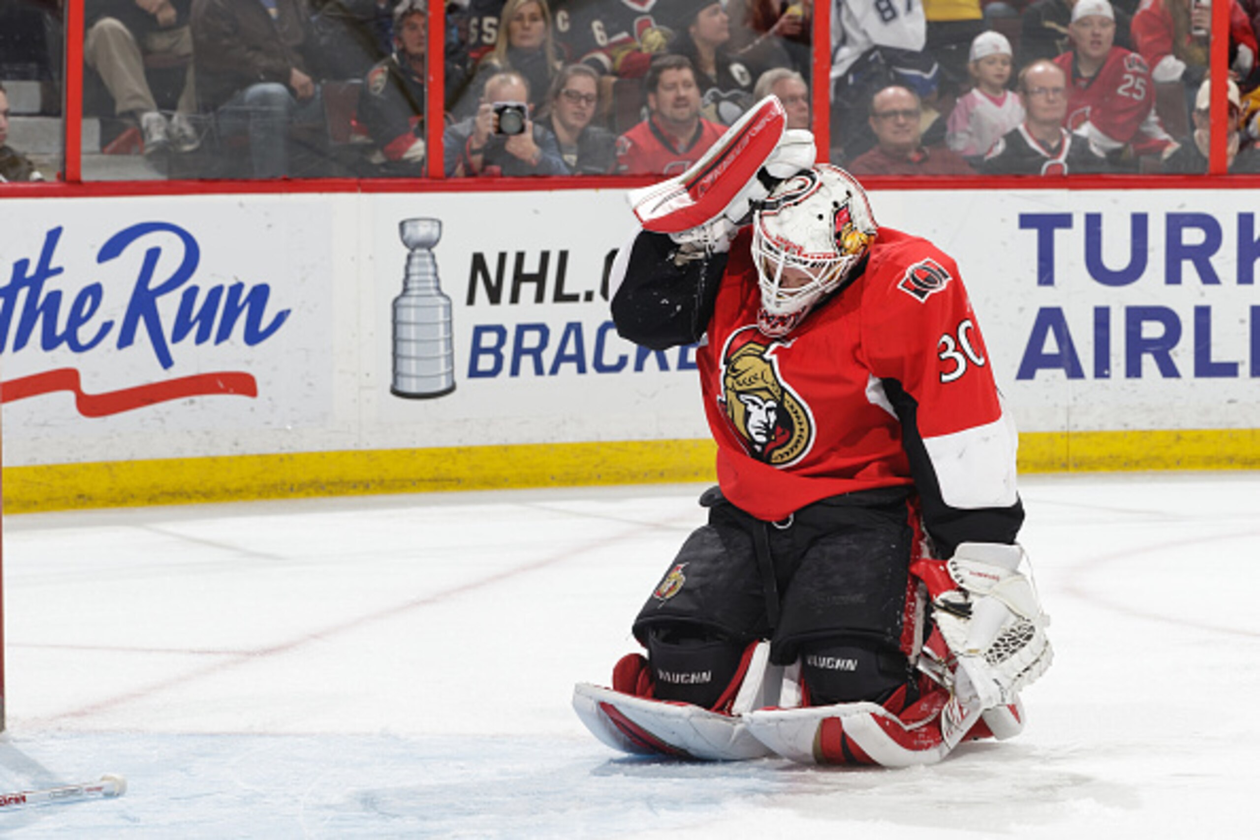 OTTAWA, ON - APRIL 7: Andrew Hammond #30 of the Ottawa Senators adjust his helmut after being hit during a play against the Pittsburgh Penguins at Canadian Tire Centre on April 7, 2015 in Ottawa, Ontario, Canada. (Photo by Jana Chytilova/NHLI via Getty Im