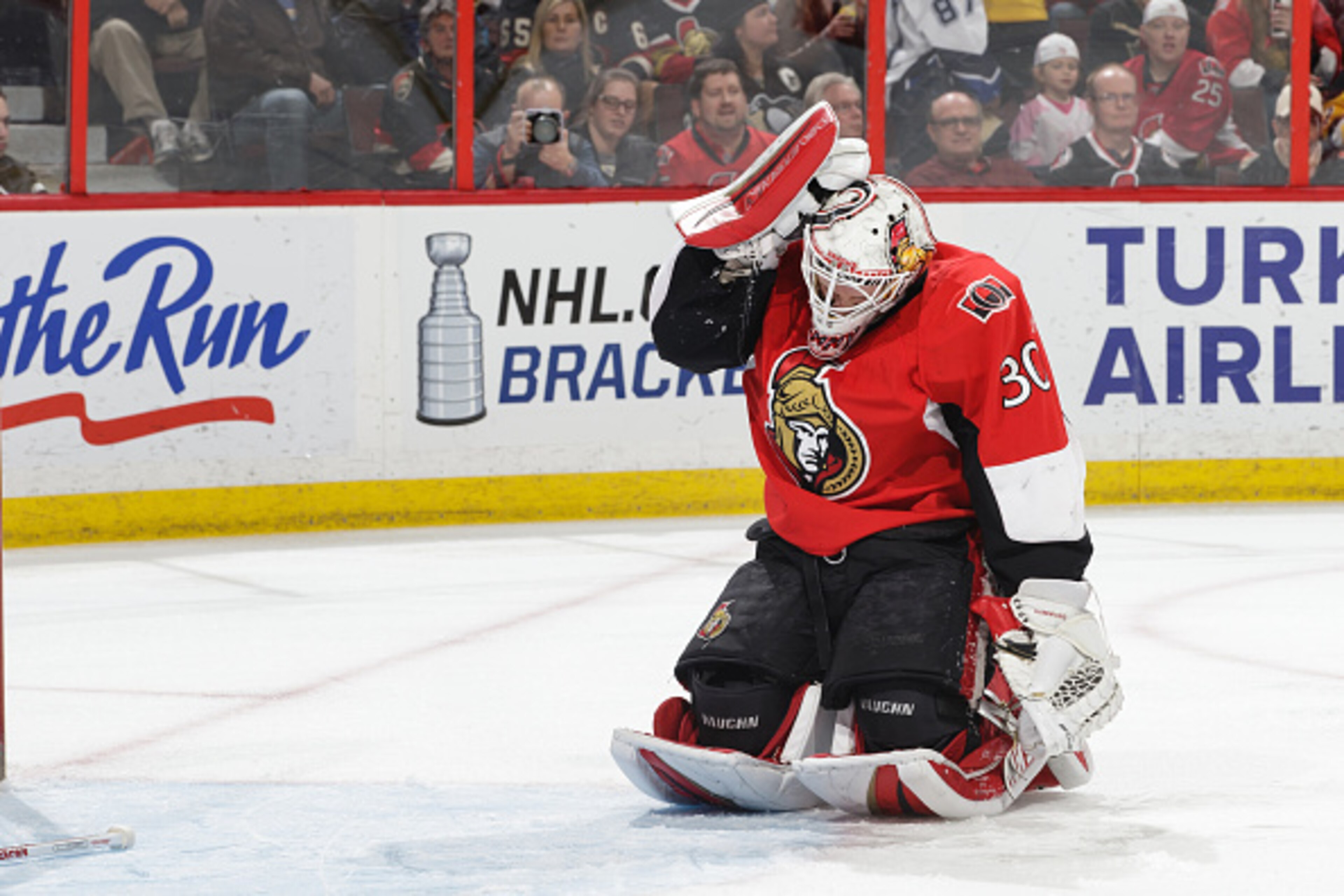 OTTAWA, ON - APRIL 7: Andrew Hammond #30 of the Ottawa Senators adjust his helmut after being hit during a play against the Pittsburgh Penguins at Canadian Tire Centre on April 7, 2015 in Ottawa, Ontario, Canada. (Photo by Jana Chytilova/NHLI via Getty Im