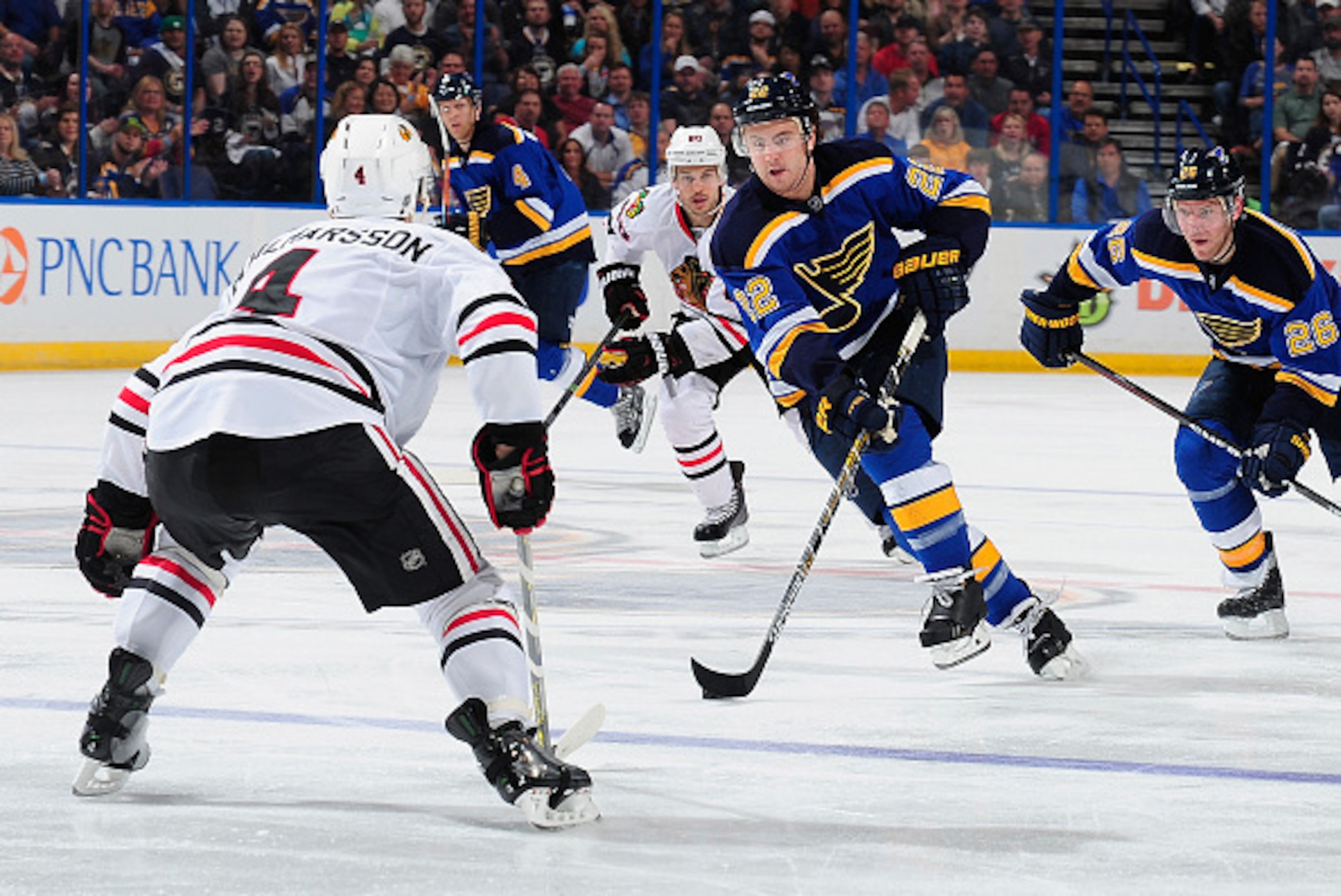 ST. LOUIS, MO - APRIL 9: Kevin Shattenkirk #22 of the St. Louis Blues handles the puck as Niklas Hjalmarsson #4 of the Chicago Blackhawks defends on April 9, 2015 at the Scottrade Center in St. Louis, Missouri. (Photo by Jeff Curry/NHLI via Getty Images)