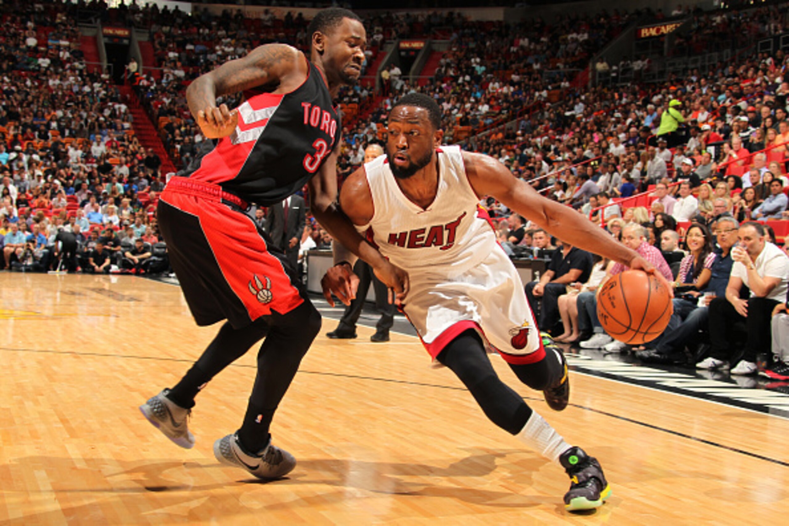 MIAMI, FL - APRIL 11: Dwyane Wade #3 of the Miami Heat drives against Terrence Ross #31 of the Toronto Raptors on April 11, 2015 at American Airlines Arena in Miami, Florida.  NOTE TO USER: User expressly acknowledges and agrees that, by downloading and o