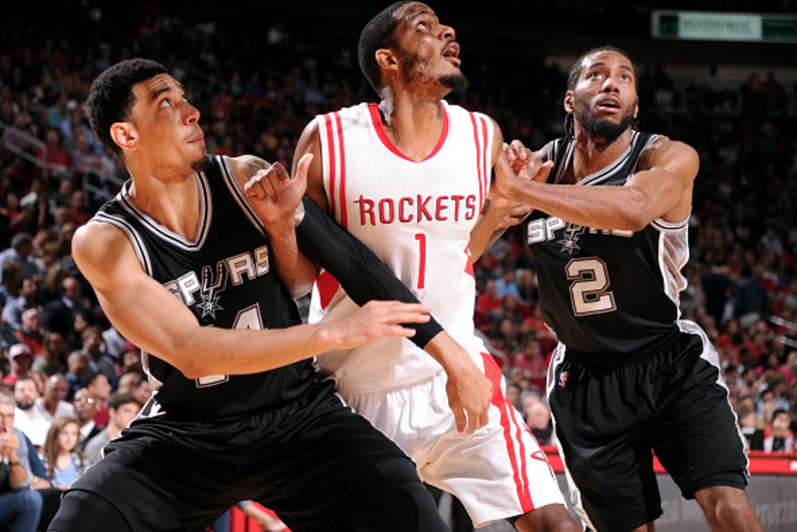 HOUSTON, TX - APRIL 10: Trevor Ariza #1 of the Houston Rockets battles for position against Danny Green #14 and Kawhi Leonard #2 of the San Antonio Spurs on April 10, 2015 at the Toyota Center in Houston, Texas. NOTE TO USER: User expressly acknowledges a