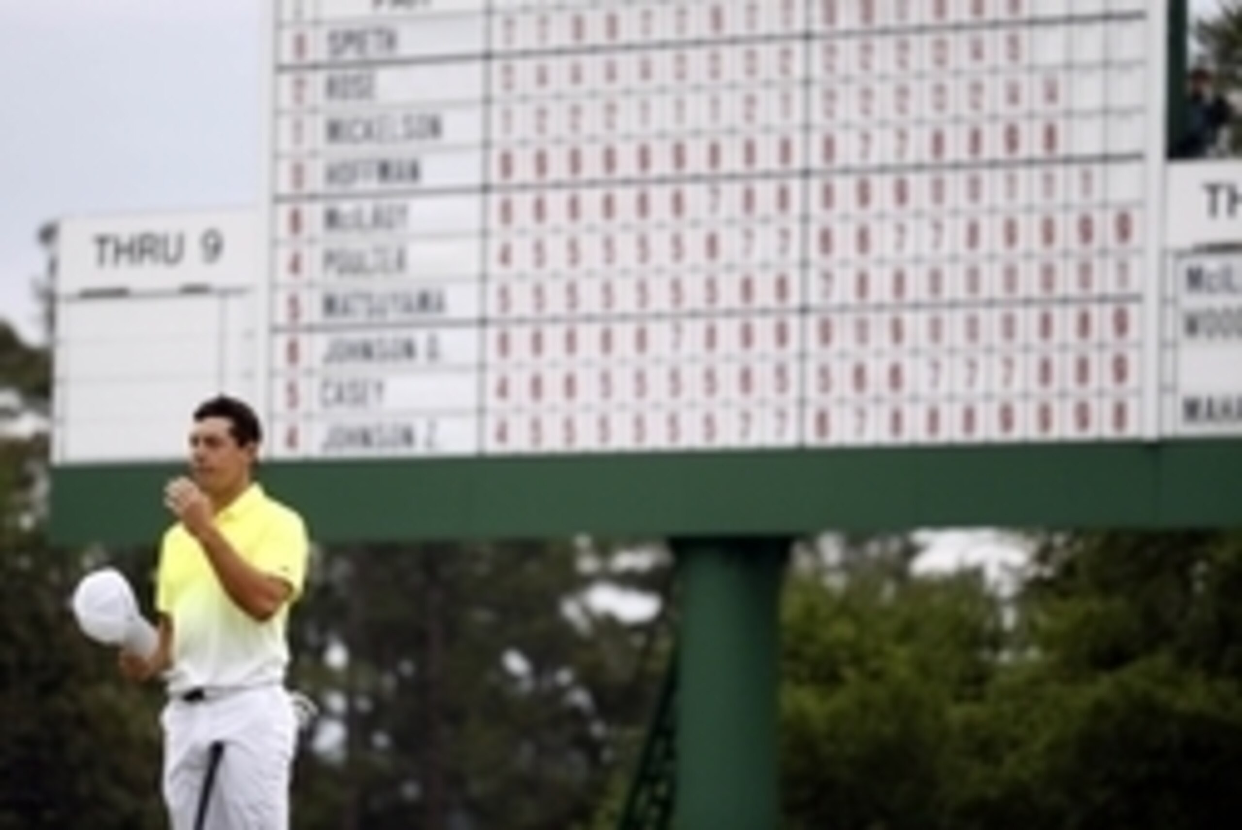 Apr 12, 2015; Augusta, GA, USA; Rory McIlroy stands under the leaderboard on the 18th green during the final round of The Masters golf tournament at Augusta National Golf Club. Mandatory Credit: Rob Schumacher-USA TODAY Sports