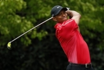 Apr 12, 2015; Augusta, GA, USA; Tiger Woods hits his tee shot on the 7th hole during the final round of The Masters golf tournament at Augusta National Golf Club. Mandatory Credit: Rob Schumacher-USA TODAY Sports