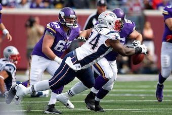 Sep 14, 2014; Minneapolis, MN, USA; New England Patriots defensive tackle Dominique Easley (74) intercepts a pass in front of Minnesota Vikings guard Brandon Fusco (63) and center John Sullivan (65) in the fourth quarter at TCF Bank Stadium. The Patriots