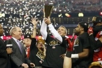 Jan 12, 2015; Arlington, TX, USA; Ohio State Buckeyes head coach Urban Meyer hoists the College Football Playoff trophy after the game against Oregon Ducks in the 2015 CFP National Championship Game at AT&T Stadium. Mandatory Credit: Matthew Emmons-USA TO