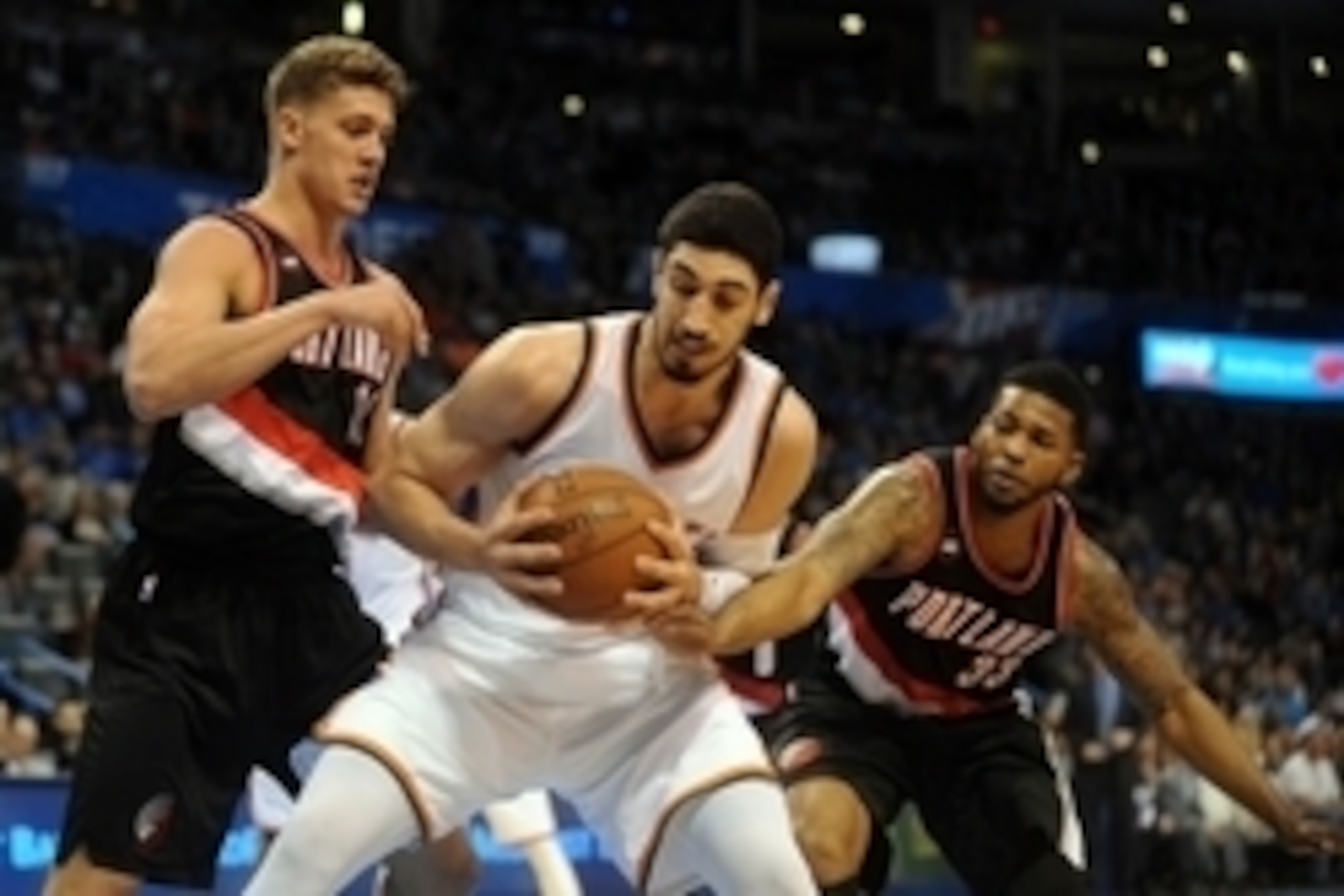 Apr 13, 2015; Oklahoma City, OK, USA; Oklahoma City Thunder center Enes Kanter (34) drives to the basket against Portland Trail Blazers center Meyers Leonard (11) and Portland Trail Blazers forward Alonzo Gee (33) during the fourth quarter at Chesapeake E