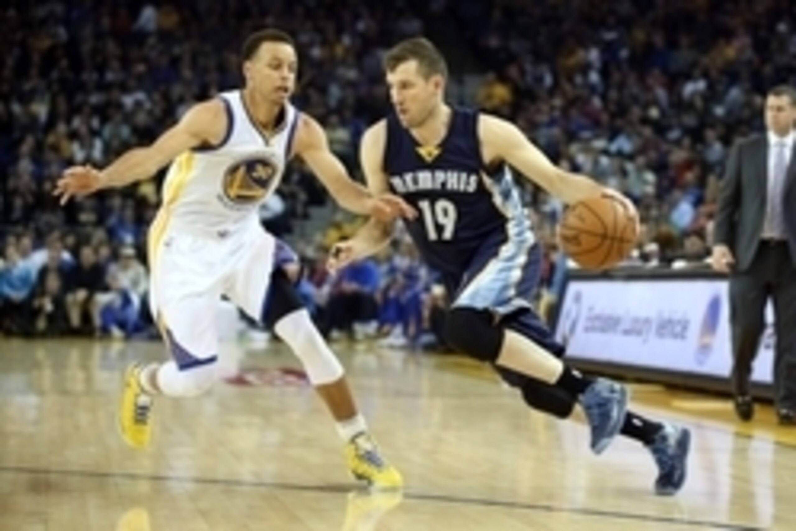 Apr 13, 2015; Oakland, CA, USA; Memphis Grizzlies guard Beno Udrih (19) drives in against Golden State Warriors guard Stephen Curry (30) during the first quarter at Oracle Arena. Mandatory Credit: Kelley L Cox-USA TODAY Sports