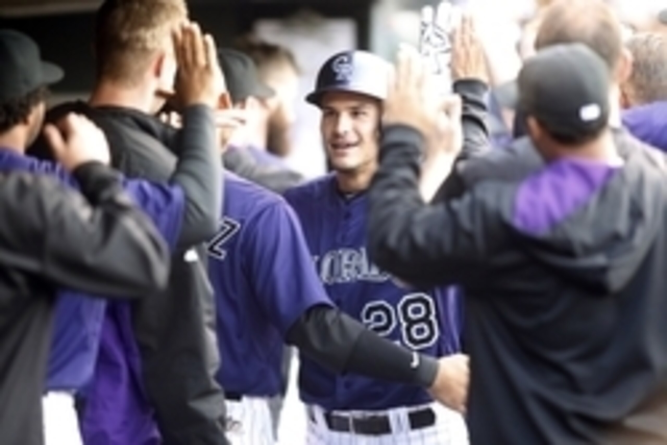 Apr 11, 2015; Denver, CO, USA; Colorado Rockies third baseman Nolan Arenado (28) celebrates with teammates after hitting a home run during the third inning against the Chicago Cubs at Coors Field. Mandatory Credit: Chris Humphreys-USA TODAY Sports