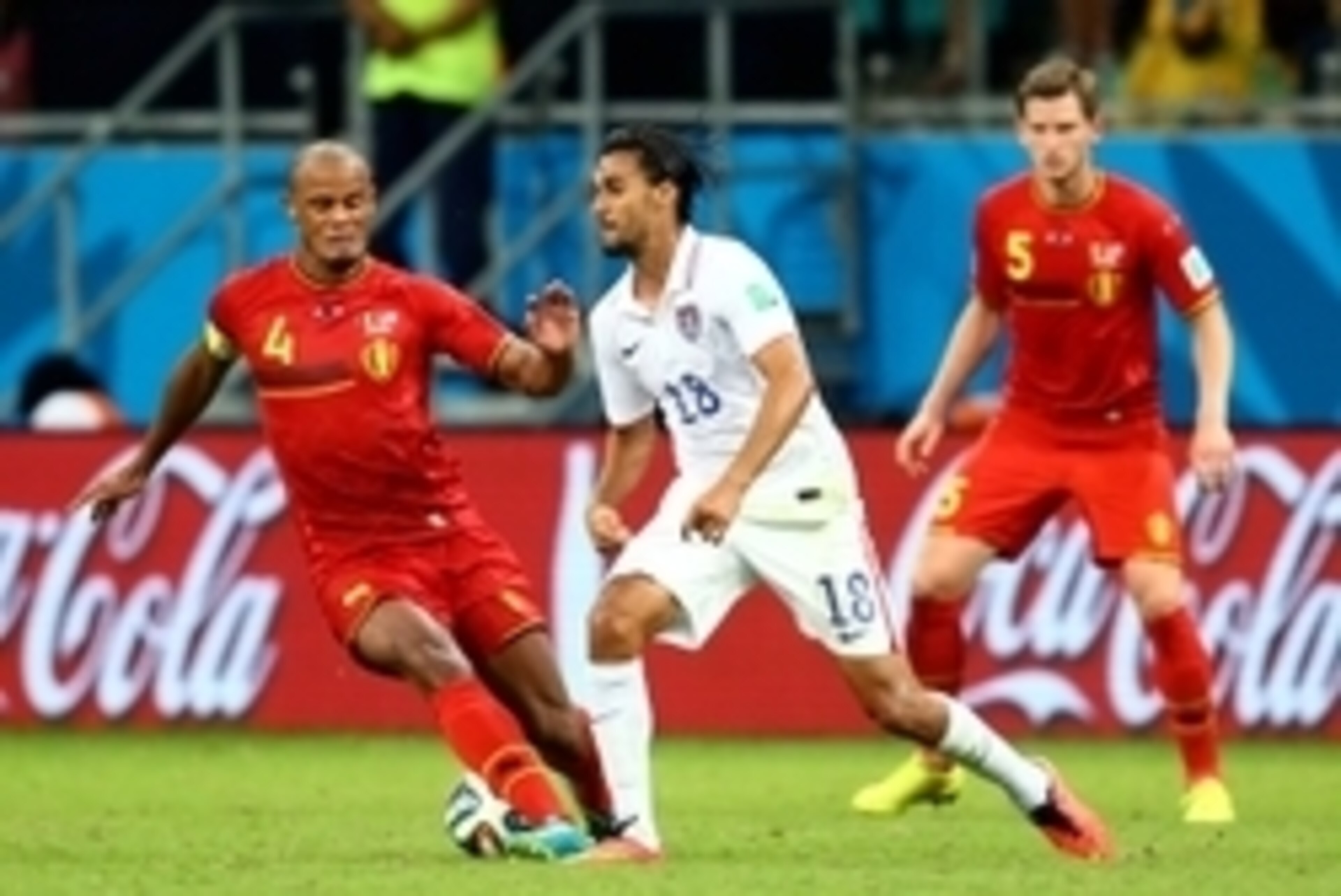 Jul 1, 2014; Salvador, BRAZIL; Belgium defender Vincent Kompany (4) against USA forward Chris Wondolowski (18) during the round of sixteen match in the 2014 World Cup at Arena Fonte Nova. Belgium defeated USA 2-1 in overtime. Mandatory Credit: Mark J. Reb