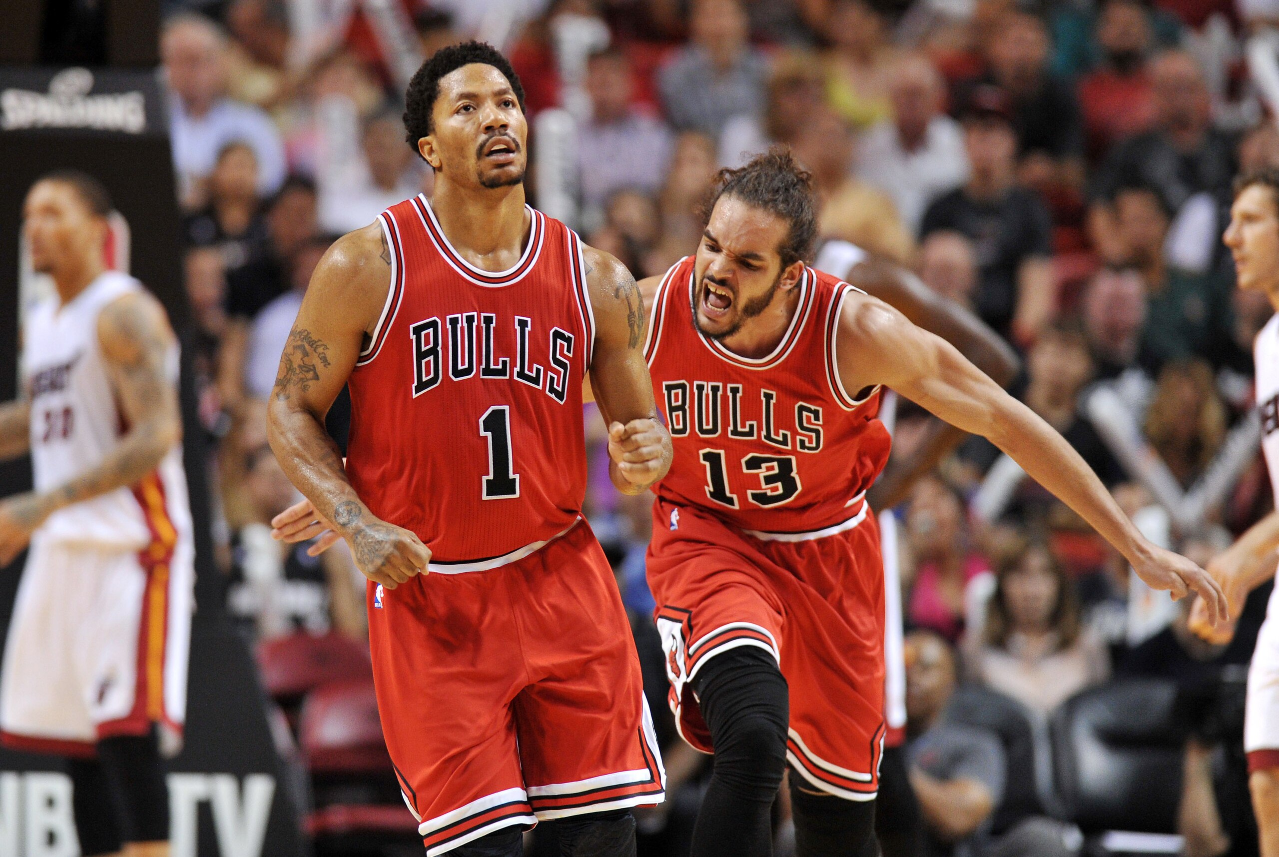Apr 9, 2015; Miami, FL, USA; Chicago Bulls center Joakim Noah (right) reacts after guard Derrick Rose (left) drives to the basket against the Miami Heat during the second half at American Airlines Arena. Mandatory Credit: Steve Mitchell-USA TODAY Sports