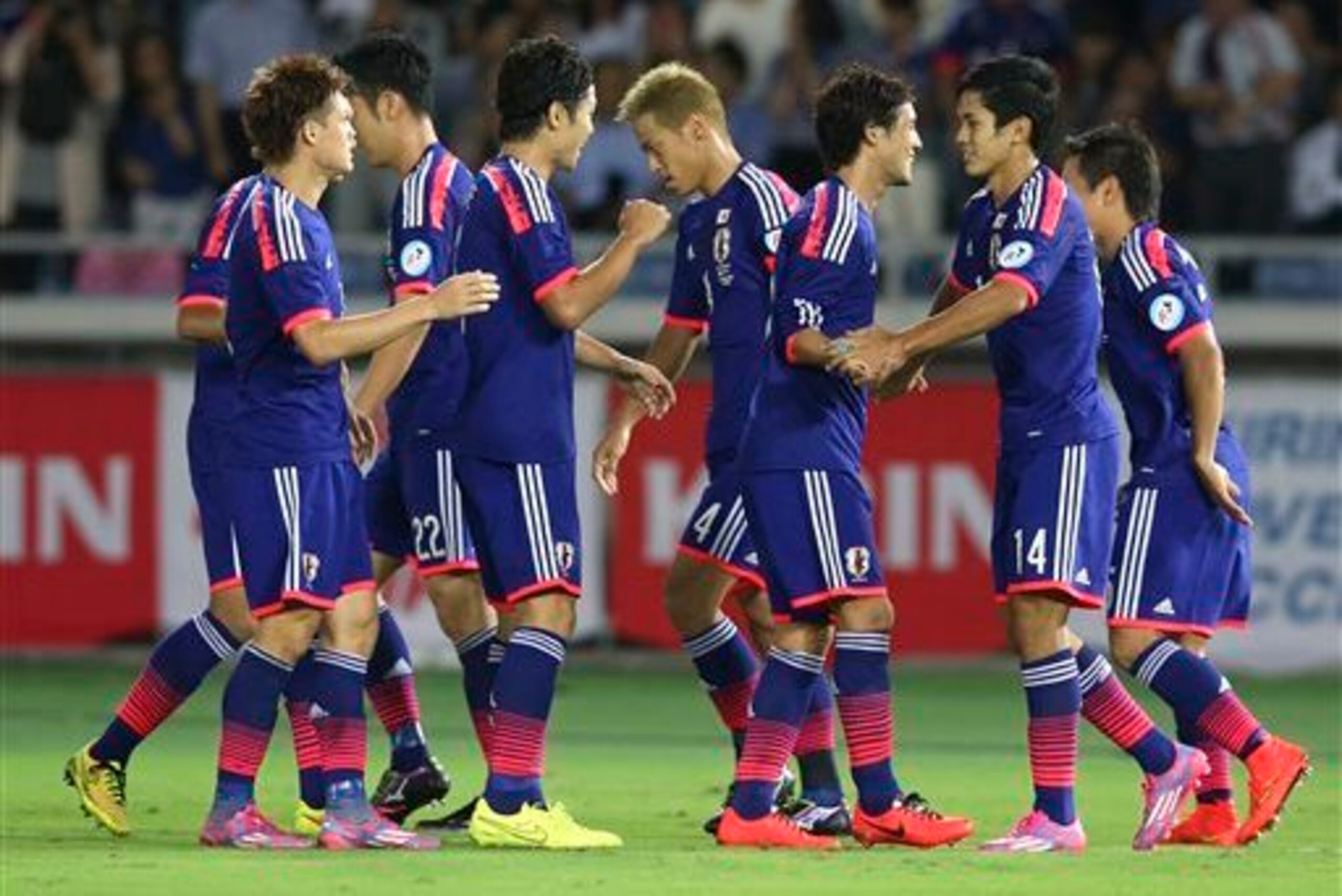 Muto, second from right, celebrates after scoring for Japan Muto, second from right, celebrates after scoring for Japan