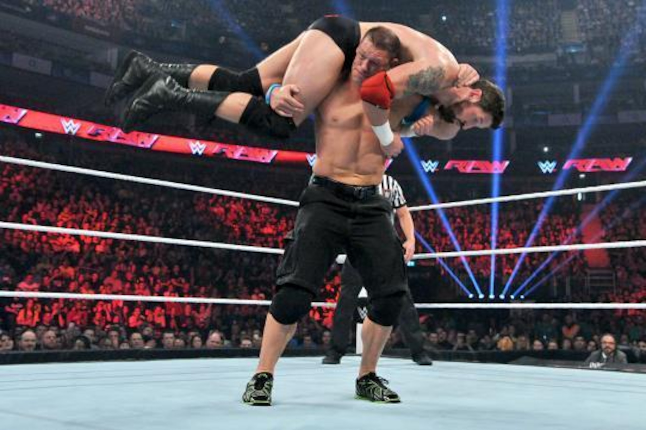 John Cena looks to hit Bad News Barrett with the Attitude Adjustment.