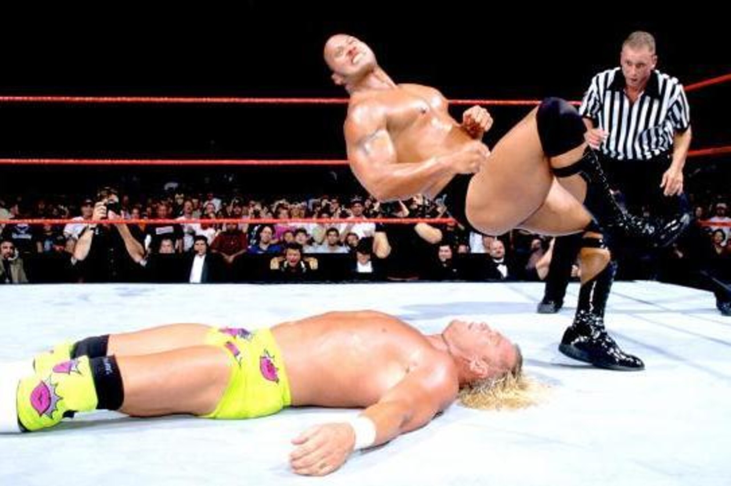 The Rock goes for an elbow drop on Billy Gunn.