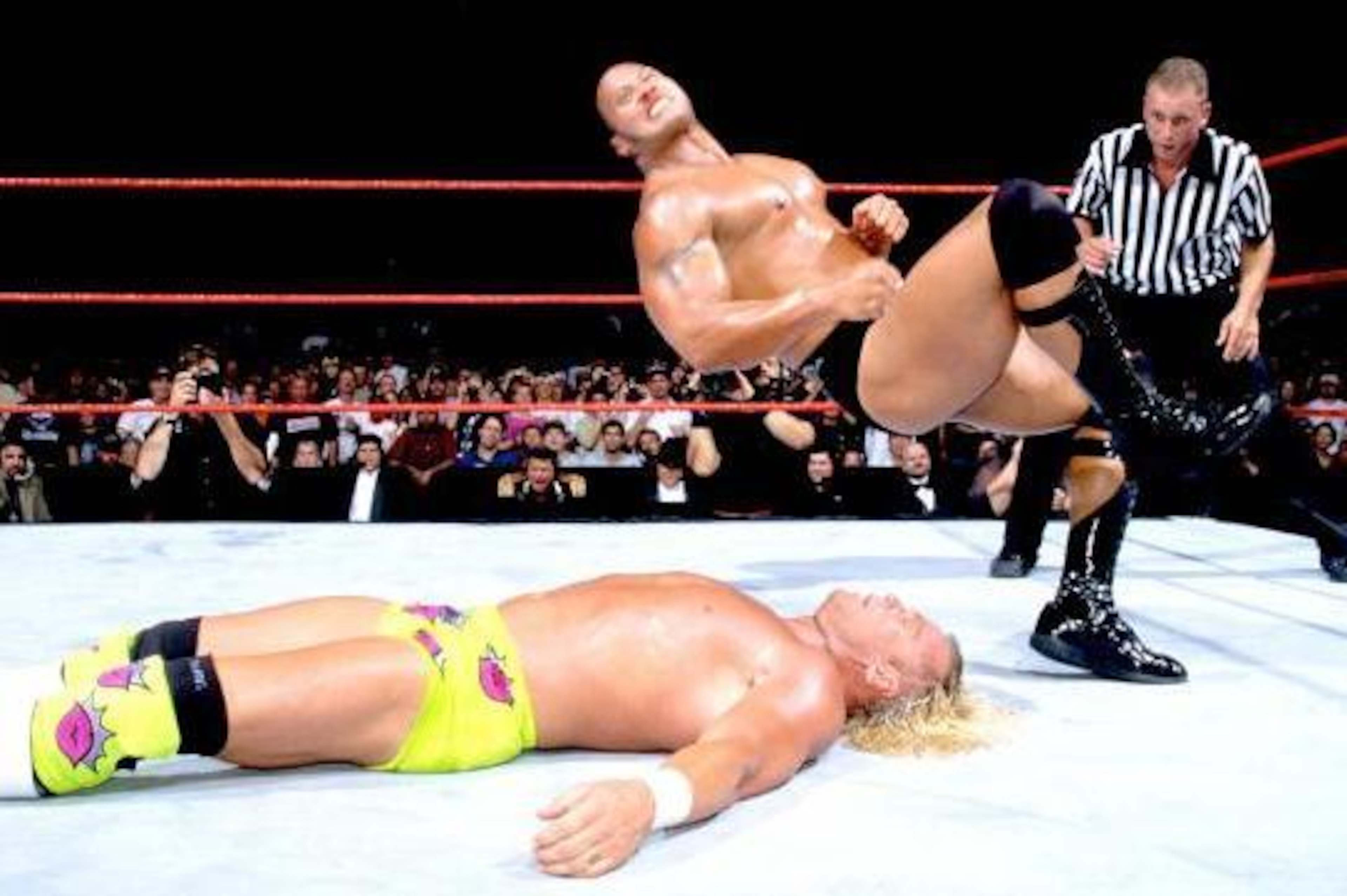 The Rock goes for an elbow drop on Billy Gunn.