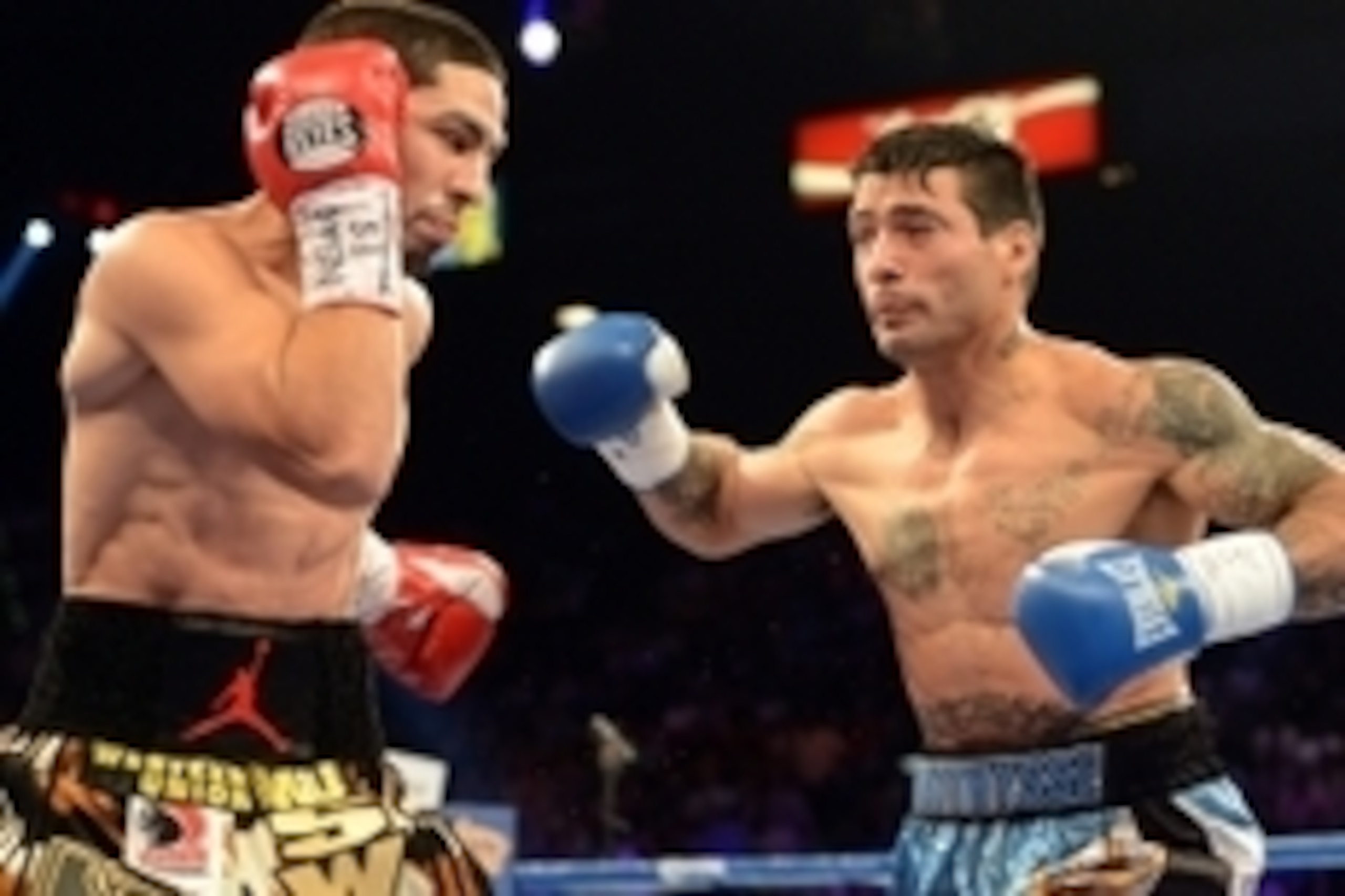 Sep 14, 2013; Las Vegas, NV, USA; Danny Garcia (yellow shorts) and Lucas Matthysse battle during their during their WBC and WBA super lightweight titles fight at MGM Grand Garden Arena. Mandatory Credit: Jayne Kamin-Oncea-USA TODAY Sports