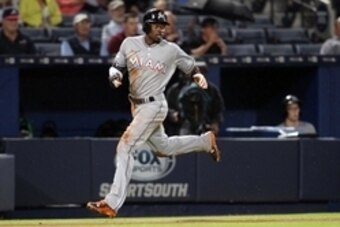 Apr 14, 2015; Atlanta, GA, USA; Miami Marlins second baseman Dee Gordon (9) scores a run against the Atlanta Braves in the fourth inning at Turner Field. Mandatory Credit: Brett Davis-USA TODAY Sports