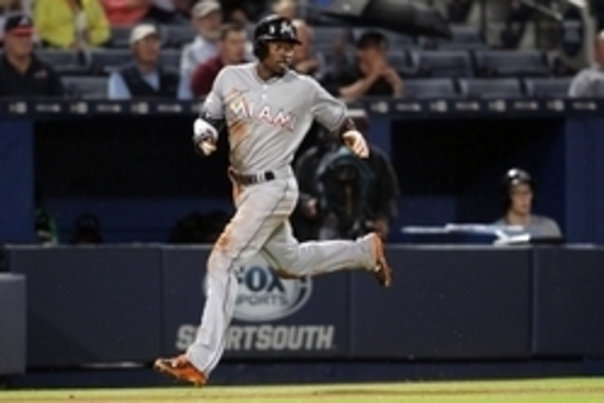 Apr 14, 2015; Atlanta, GA, USA; Miami Marlins second baseman Dee Gordon (9) scores a run against the Atlanta Braves in the fourth inning at Turner Field. Mandatory Credit: Brett Davis-USA TODAY Sports Apr 14, 2015; Atlanta, GA, USA; Miami Marlins second baseman Dee Gordon (9) scores a run against the Atlanta Braves in the fourth inning at Turner Field. Mandatory Credit: Brett Davis-USA TODAY Sports