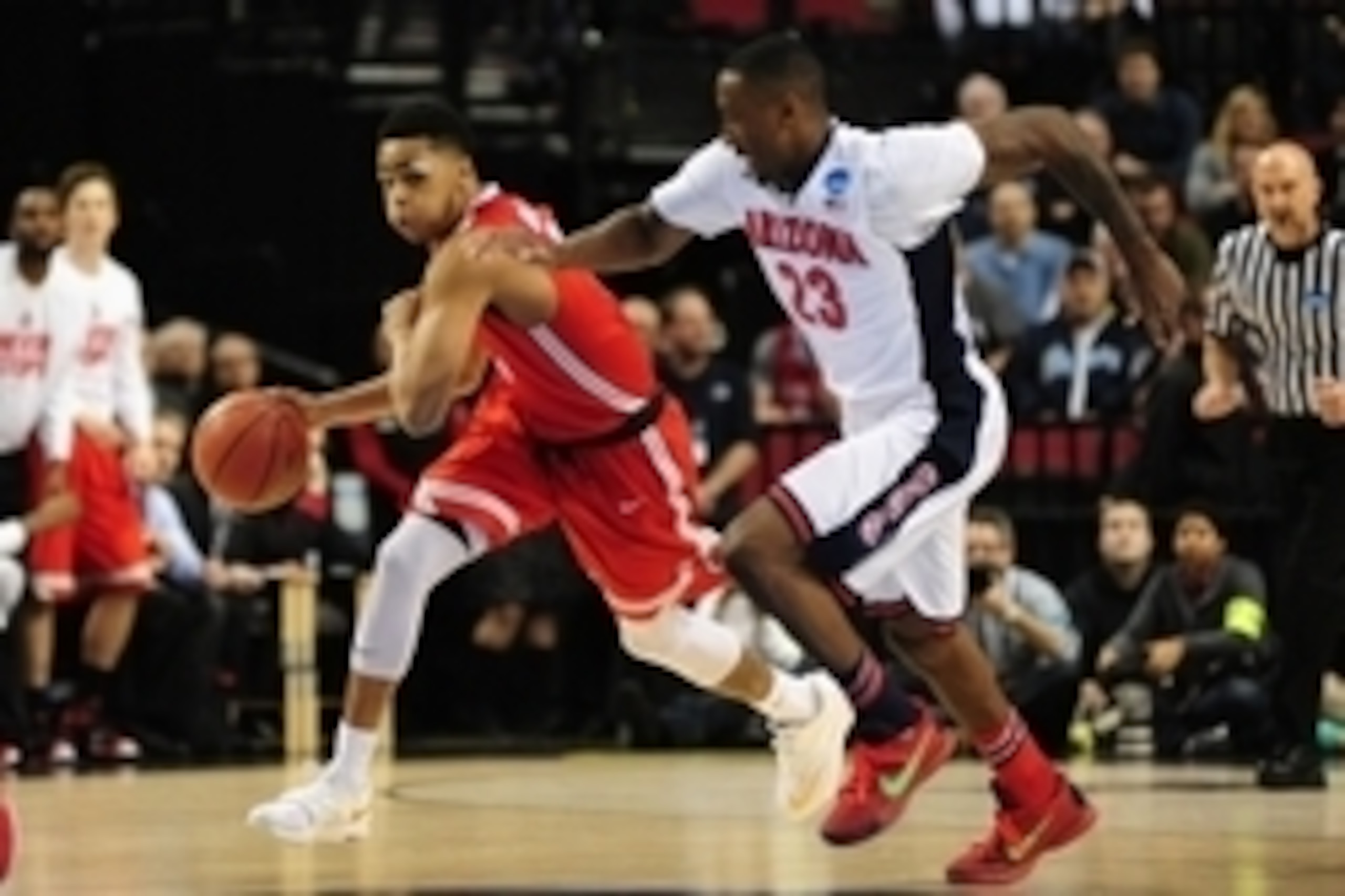 Mar 21, 2015; Portland, OR, USA; Ohio State Buckeyes guard D'Angelo Russell (left) dribbles against Arizona Wildcats forward Rondae Hollis-Jefferson (23) during the first half in the third round of the 2015 NCAA Tournament at Moda Center. Mandatory Credit