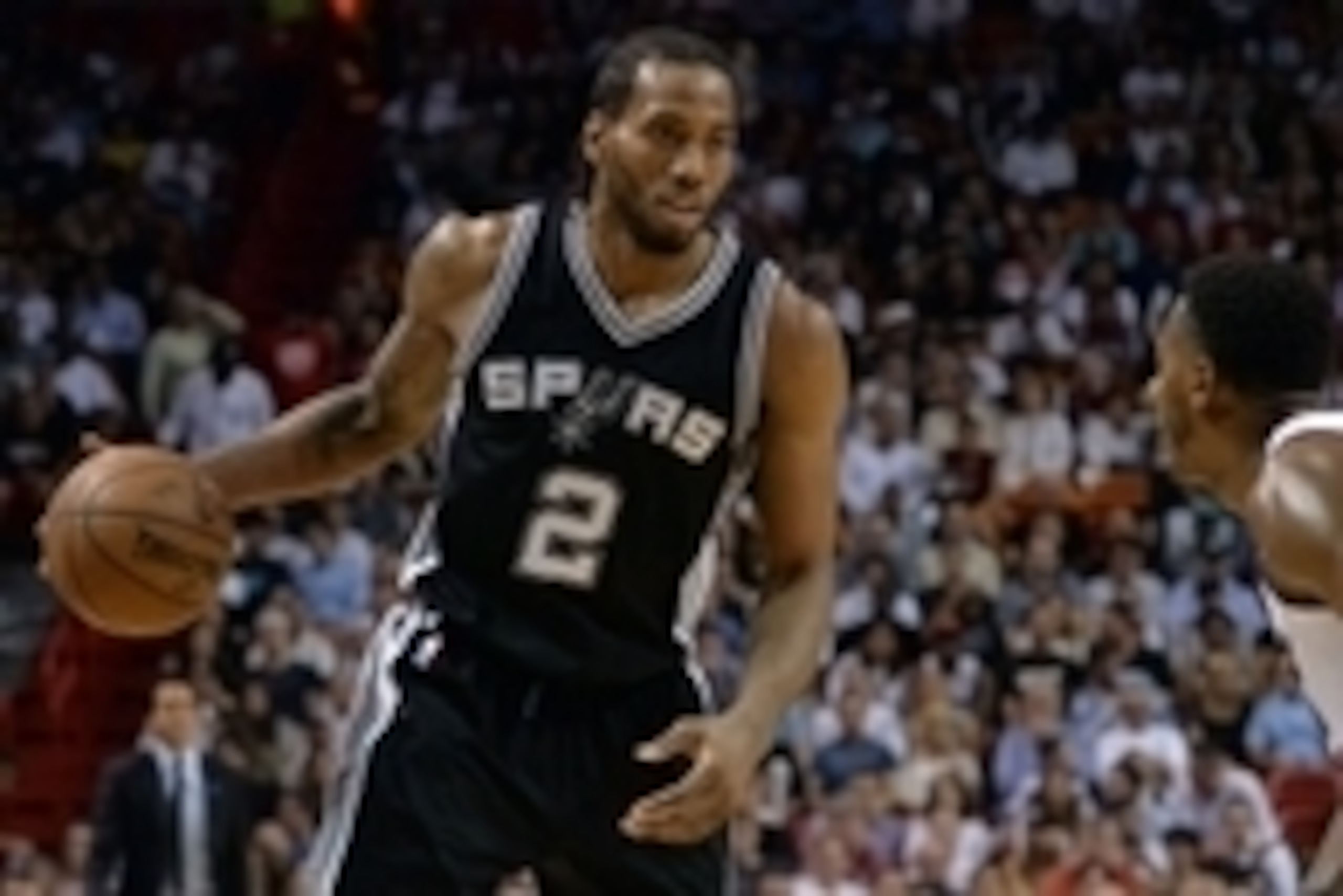 Mar 31, 2015; Miami, FL, USA; San Antonio Spurs forward Kawhi Leonard (2) dribbles against Miami Heat guard Mario Chalmers (15) during the second half at American Airlines Arena. Mandatory Credit: Steve Mitchell-USA TODAY Sports