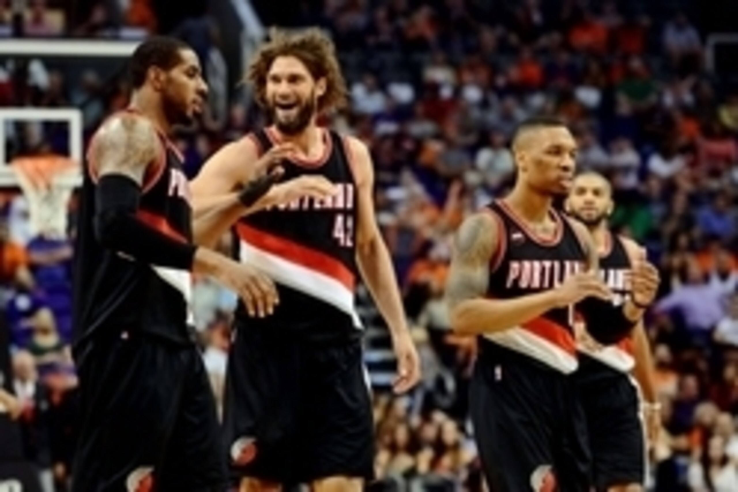 Mar 27, 2015; Phoenix, AZ, USA; Portland Trail Blazers forward LaMarcus Aldridge (12) celebrates with center Robin Lopez (42) after making a basket against the Phoenix Suns during the second half at US Airways Center. The Trail Blazers won the game 87-81.
