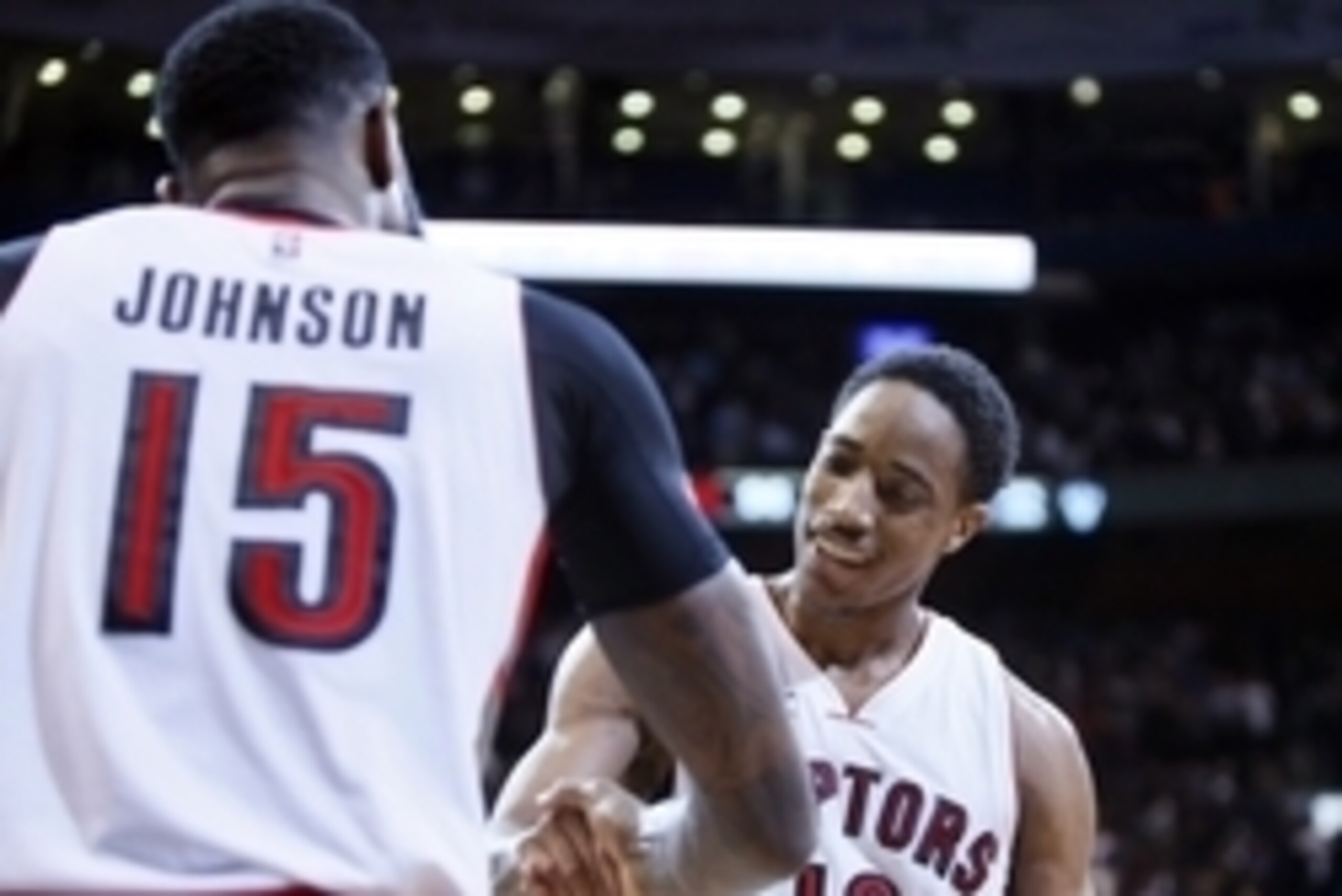 Mar 30, 2015; Toronto, Ontario, CAN; Toronto Raptors forward Amir Johnson (15) and guard DeMar DeRozan (10) celebrate a win over the Houston Rockets at the Air Canada Centre. Toronto defeated Houston 99-96. Mandatory Credit: John E. Sokolowski-USA TODAY S