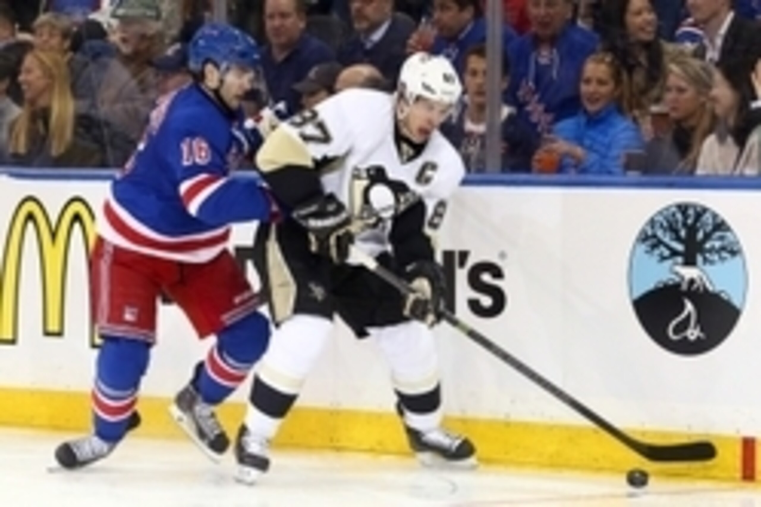 Apr 16, 2015; New York, NY, USA; Pittsburgh Penguins center Sidney Crosby (87) controls the puck in front of New York Rangers center Derick Brassard (16) during the third period of game one of the first round of the the 2015 Stanley Cup Playoffs at Madiso