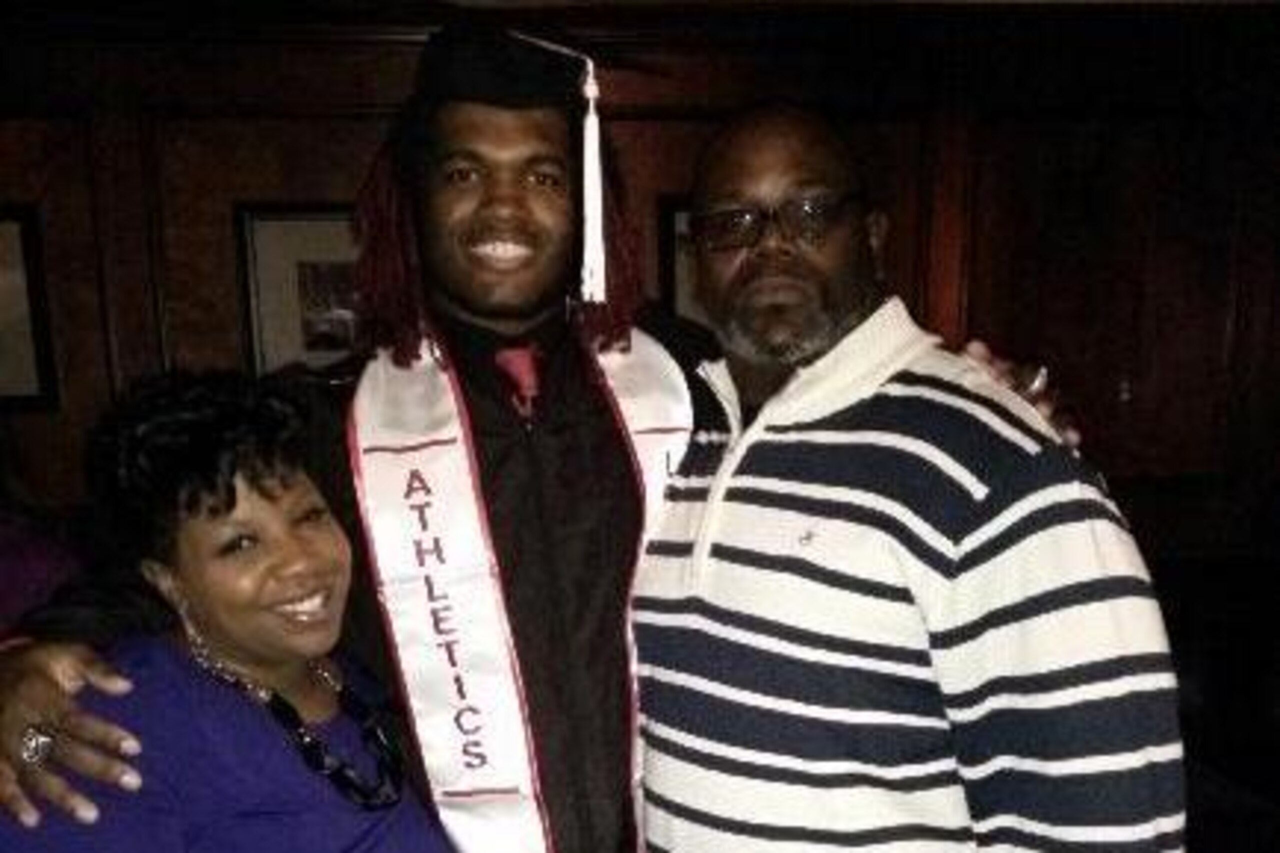 Maurice Hart, right, and his wife with Lorenzo Mauldin after his college graduation.
