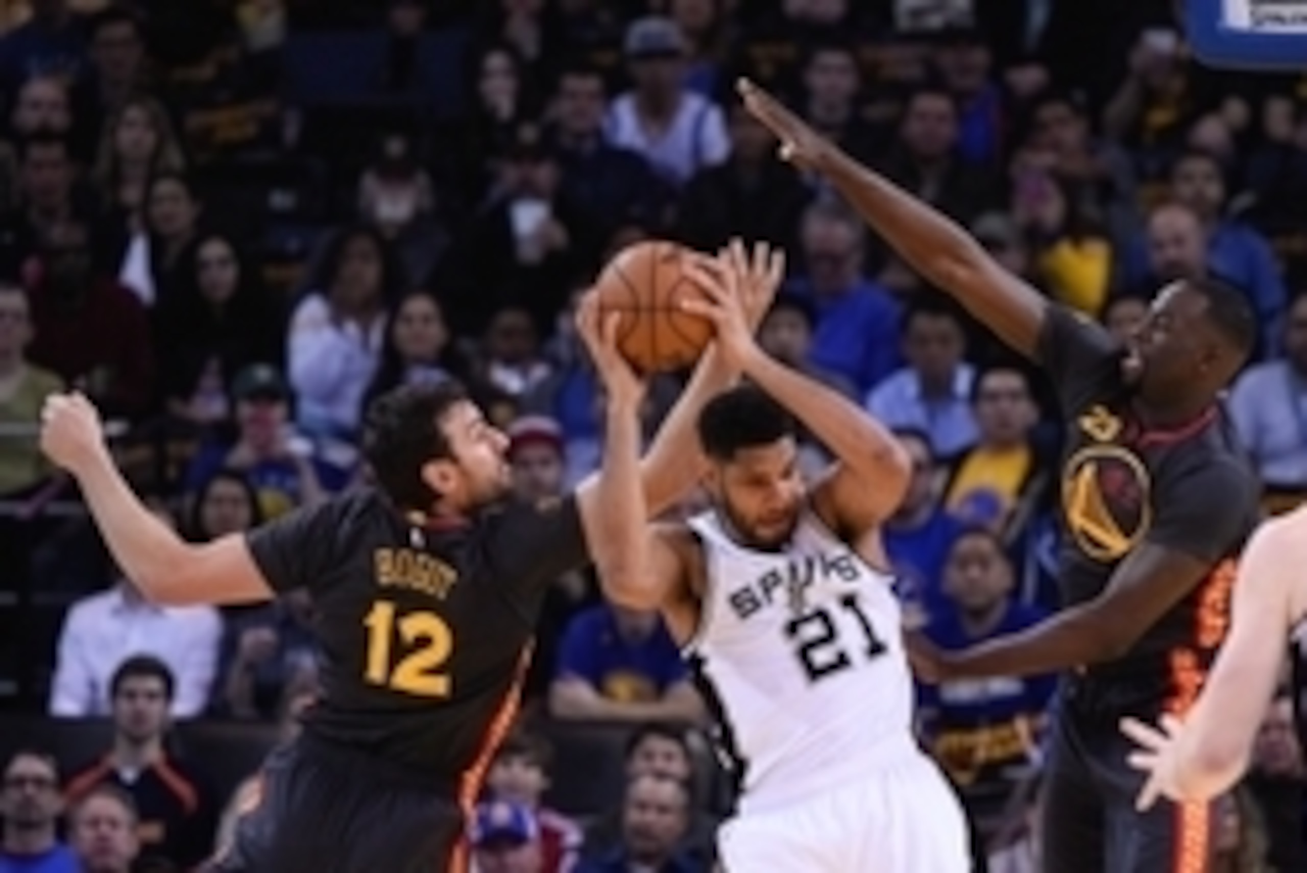 February 20, 2015; Oakland, CA, USA; San Antonio Spurs forward Tim Duncan (21) grabs a rebound against Golden State Warriors center Andrew Bogut (12) and forward Draymond Green (23) during the first quarter at Oracle Arena. The Warriors defeated the Spurs