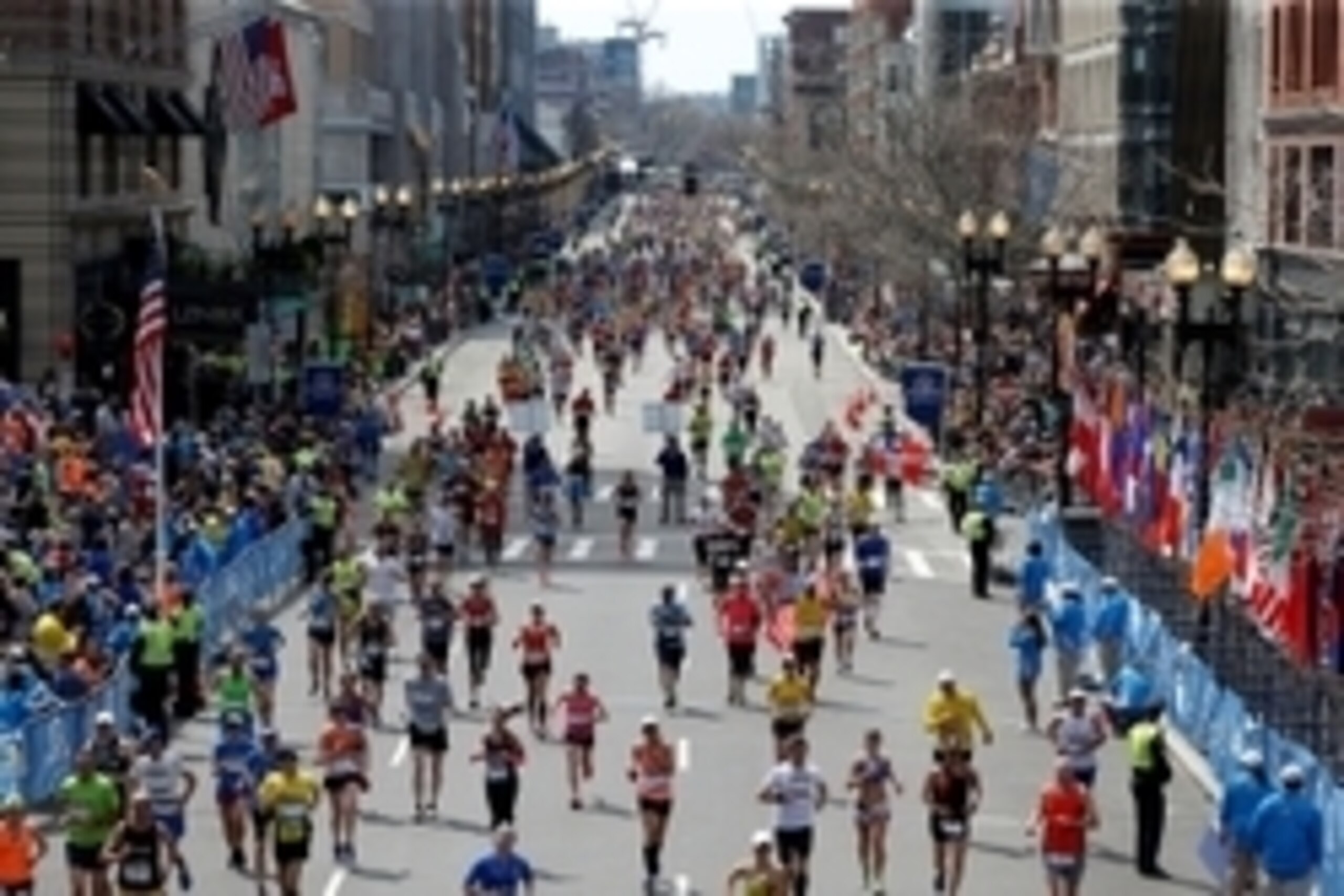 Apr 21, 2014; Boston, MA, USA; Runners stream down Boylston Street towards the finish line during the 2014 Boston Marathon. Mandatory Credit: Greg M. Cooper-USA TODAY Sports