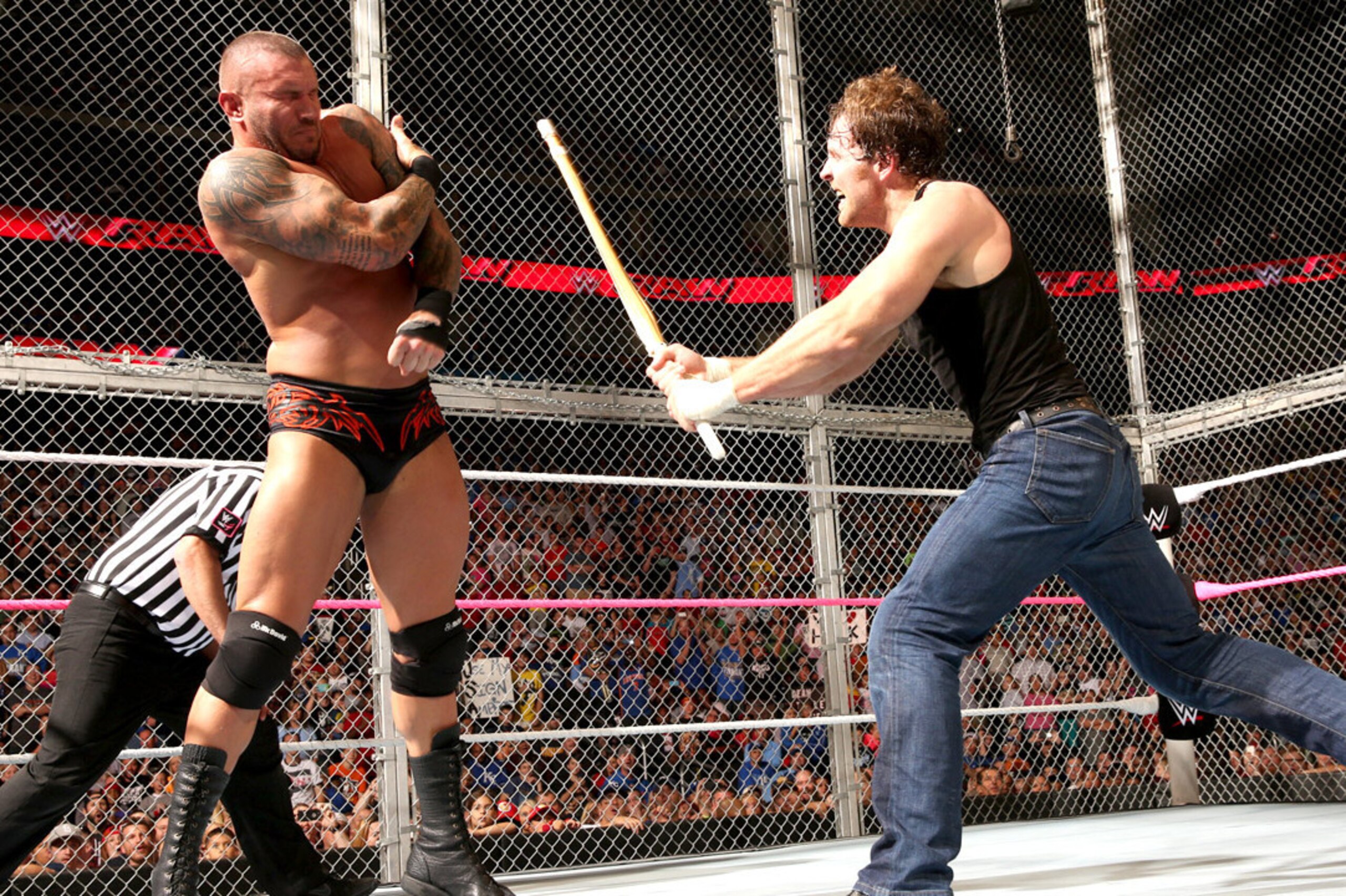 Dean Ambrose attacks Randy Orton with a Kendo stick. Dean Ambrose attacks Randy Orton with a Kendo stick.