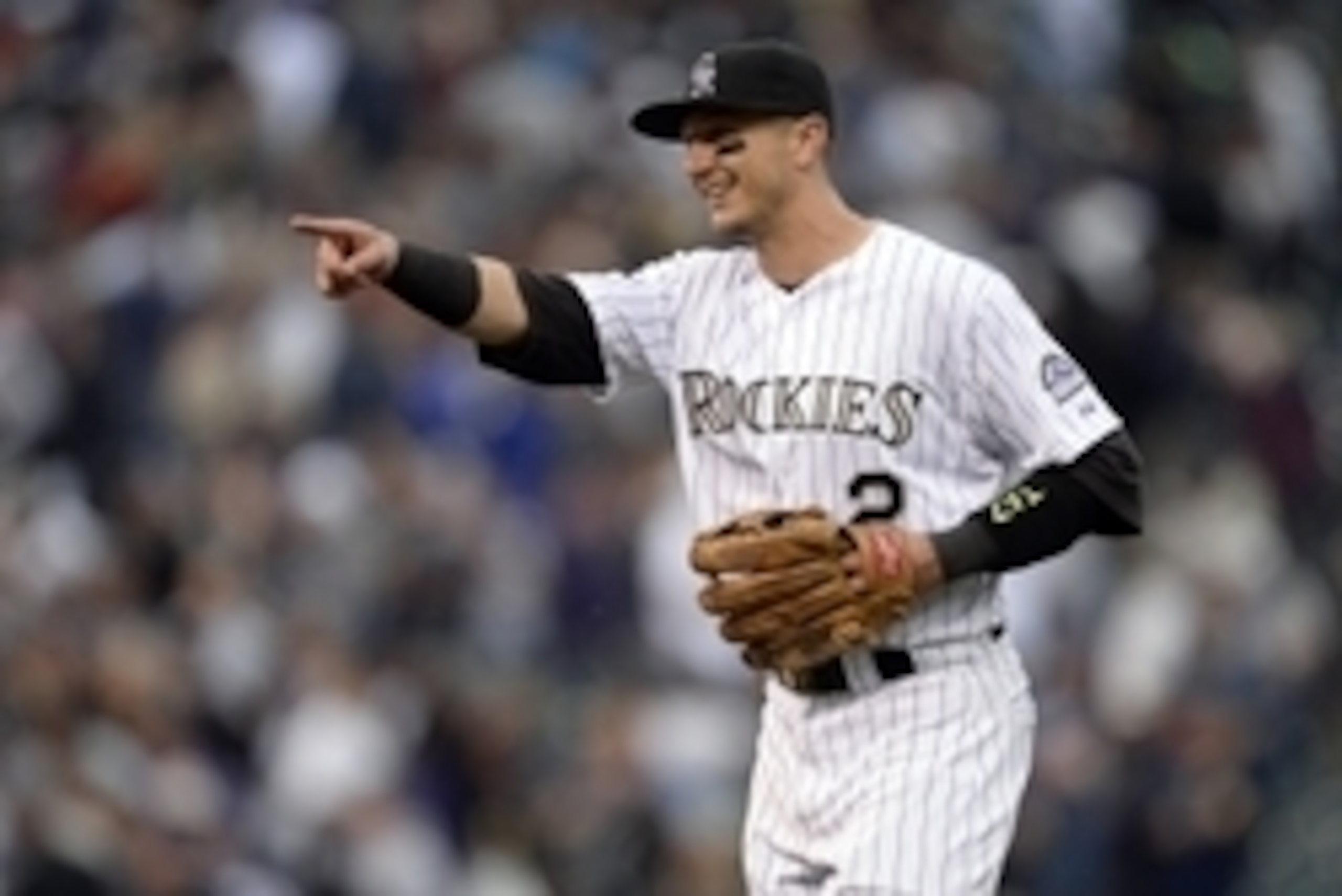 Apr 10, 2015; Denver, CO, USA; Colorado Rockies shortstop Troy Tulowitzki (2) celebrates the win over the Chicago Cubs at Coors Field. The Rockies defeated the Cubs 5-1. Mandatory Credit: Ron Chenoy-USA TODAY Sports