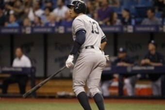 Apr 17, 2015; St. Petersburg, FL, USA; New York Yankees designated hitter Alex Rodriguez (13) hits a solo home run during the second inning against the Tampa Bay Rays at Tropicana Field. Mandatory Credit: Kim Klement-USA TODAY Sports