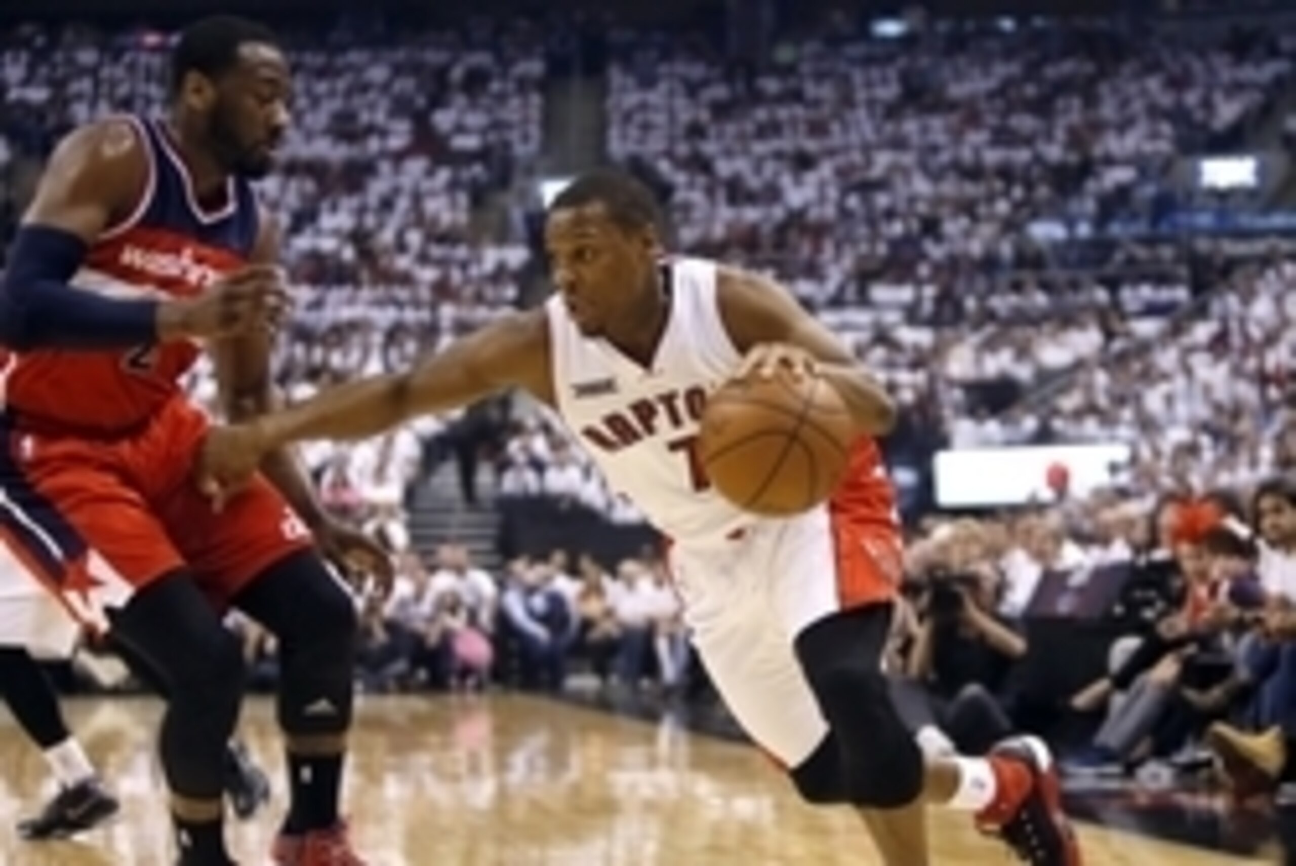 Apr 18, 2015; Toronto, Ontario, CAN; Toronto Raptors guard Kyle Lowry (7) drives to the net against Washington Wizards guard John Wall (2) during the first half in game one of the first round of the NBA Playoffs at Air Canada Centre. Mandatory Credit: Joh