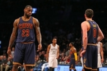 Mar 27, 2015; Brooklyn, NY, USA; Cleveland Cavaliers forward LeBron James (23) looks towards forward Kevin Love (0) against the Brooklyn Nets during the second half at Barclays Center. The Nets defeated the Cavaliers 106 - 98. Mandatory Credit: Adam Hunge