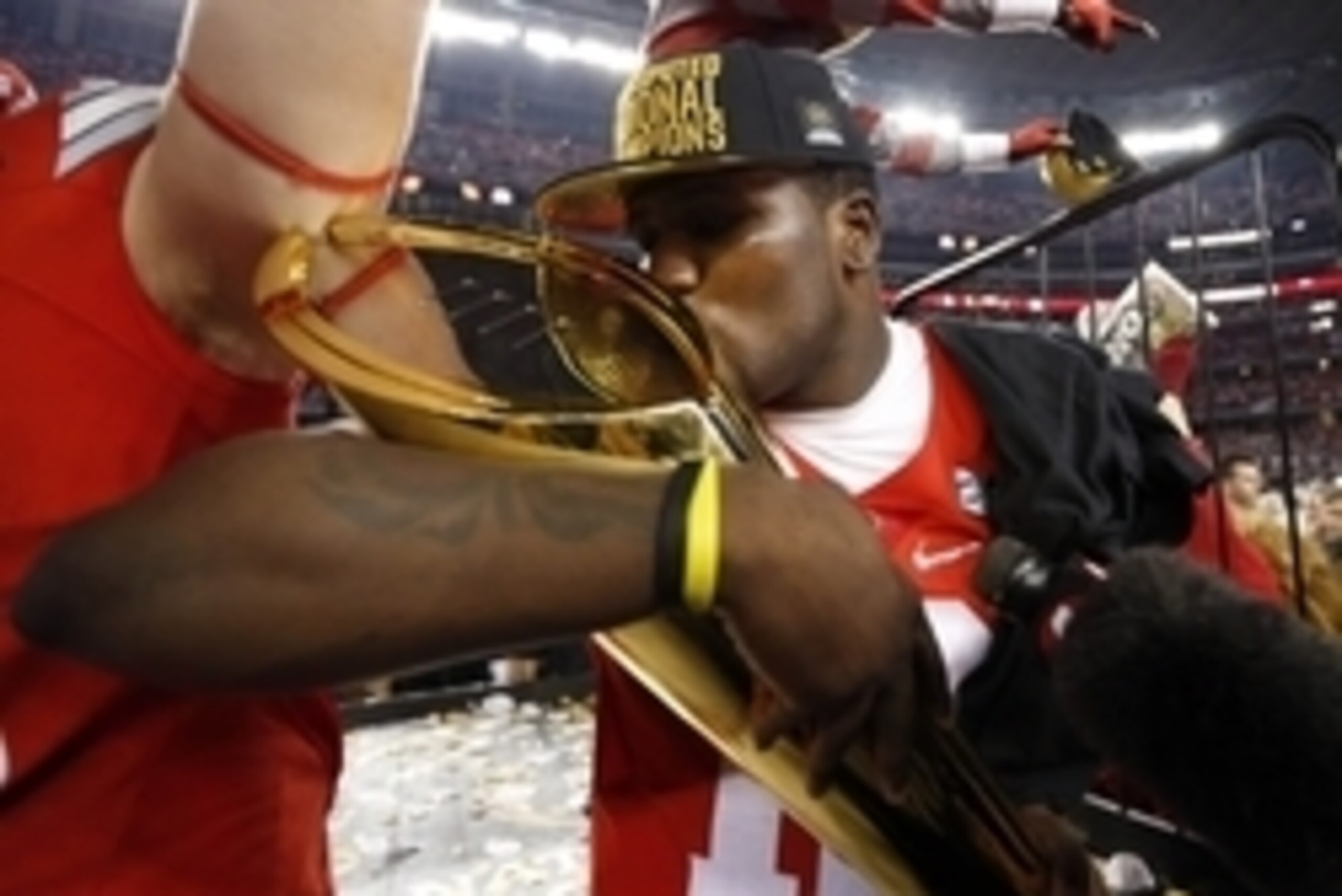 Jan 12, 2015; Arlington, TX, USA;  Ohio State Buckeyes quarterback Cardale Jones (12) kisses the national championship trophy after the 2015 CFP National Championship Game against the Oregon Ducks at AT&T Stadium. Mandatory Credit: Matthew Emmons-USA TODA