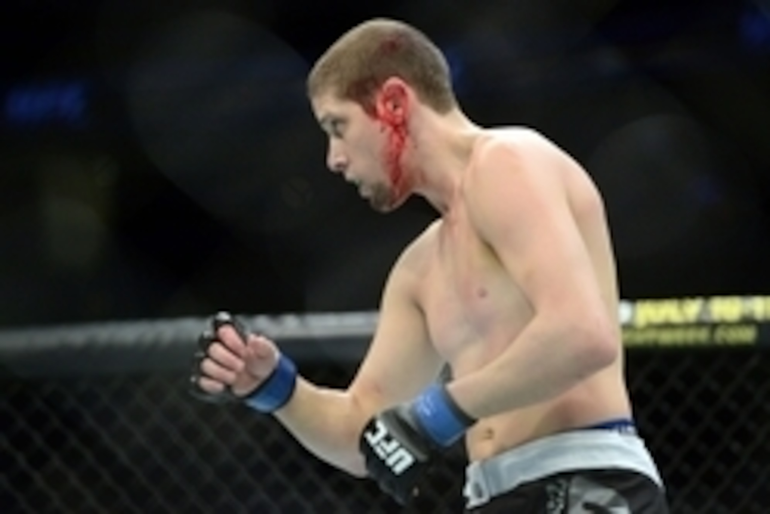 Apr 18, 2015; Newark, NJ, USA; Diego Brandao (red gloves) fights Jimmy Hettes (not pictured) during UFC Fight Night at Prudential Center. Brandao won after the fight was stopped after the first round due to a cut on the ear of Hettes. Mandatory Credit: Jo