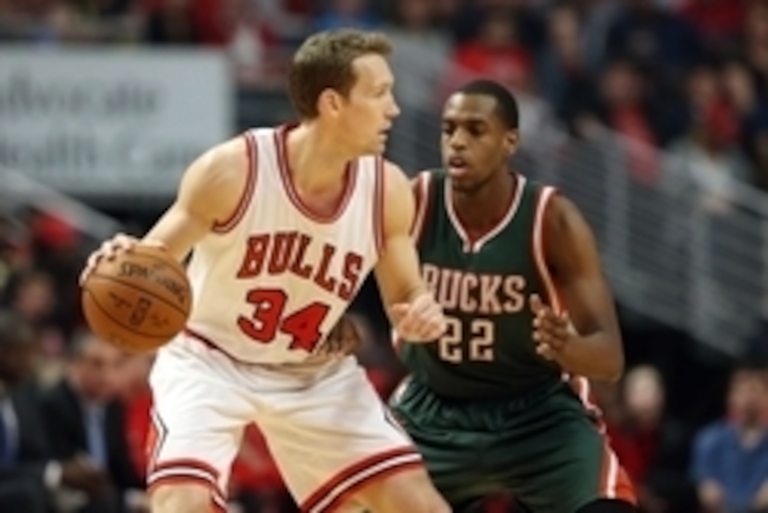 Apr 18, 2015; Chicago, IL, USA; Chicago Bulls forward Mike Dunleavy (34) is defended by Milwaukee Bucks guard Khris Middleton (22) during the first quarter in game one of the first round of the 2015 NBA Playoffs at United Center. Mandatory Credit: Jerry L
