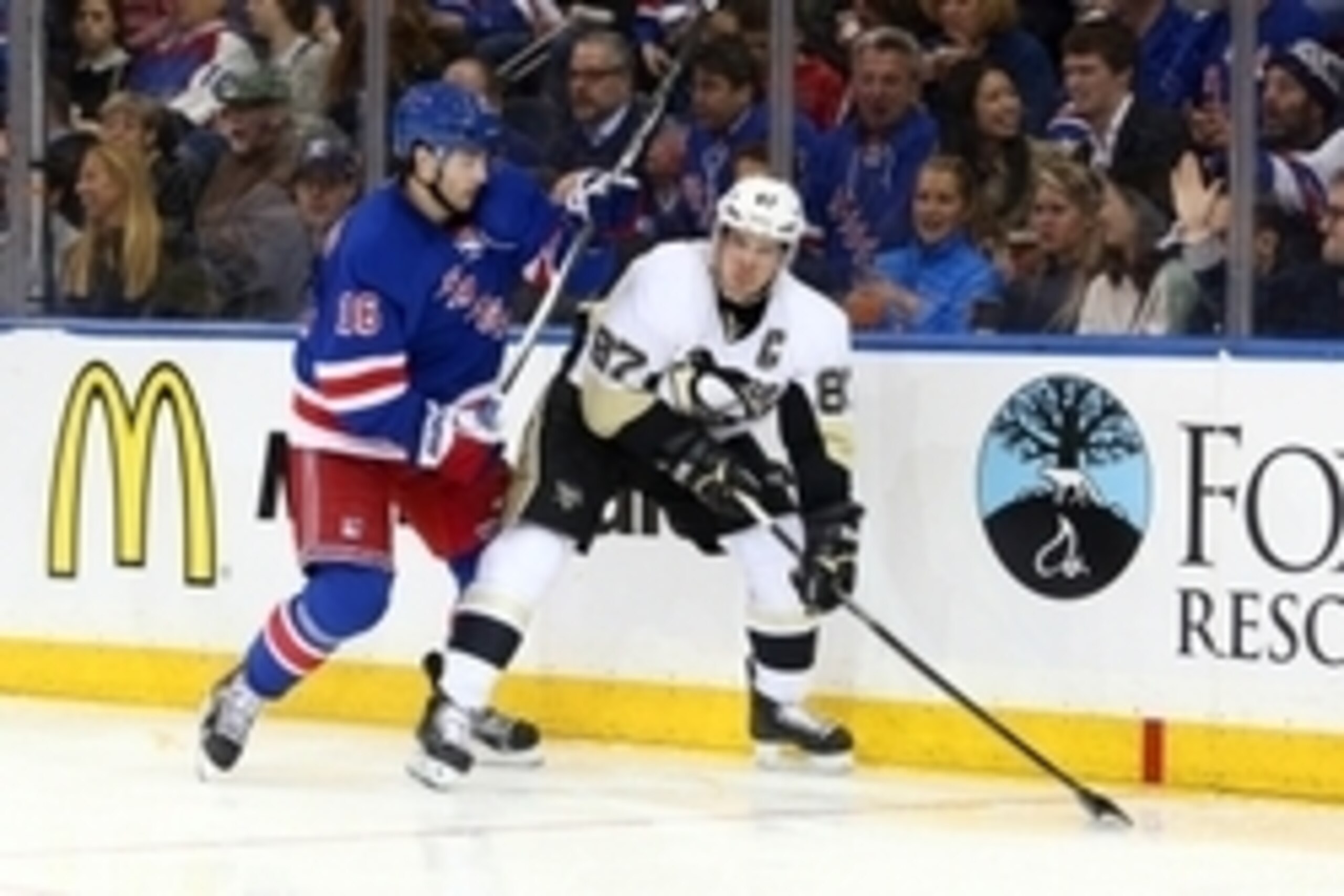 Apr 16, 2015; New York, NY, USA; Pittsburgh Penguins center Sidney Crosby (87) controls the puck in front of New York Rangers center Derick Brassard (16) during the third period of game one of the first round of the the 2015 Stanley Cup Playoffs at Madiso