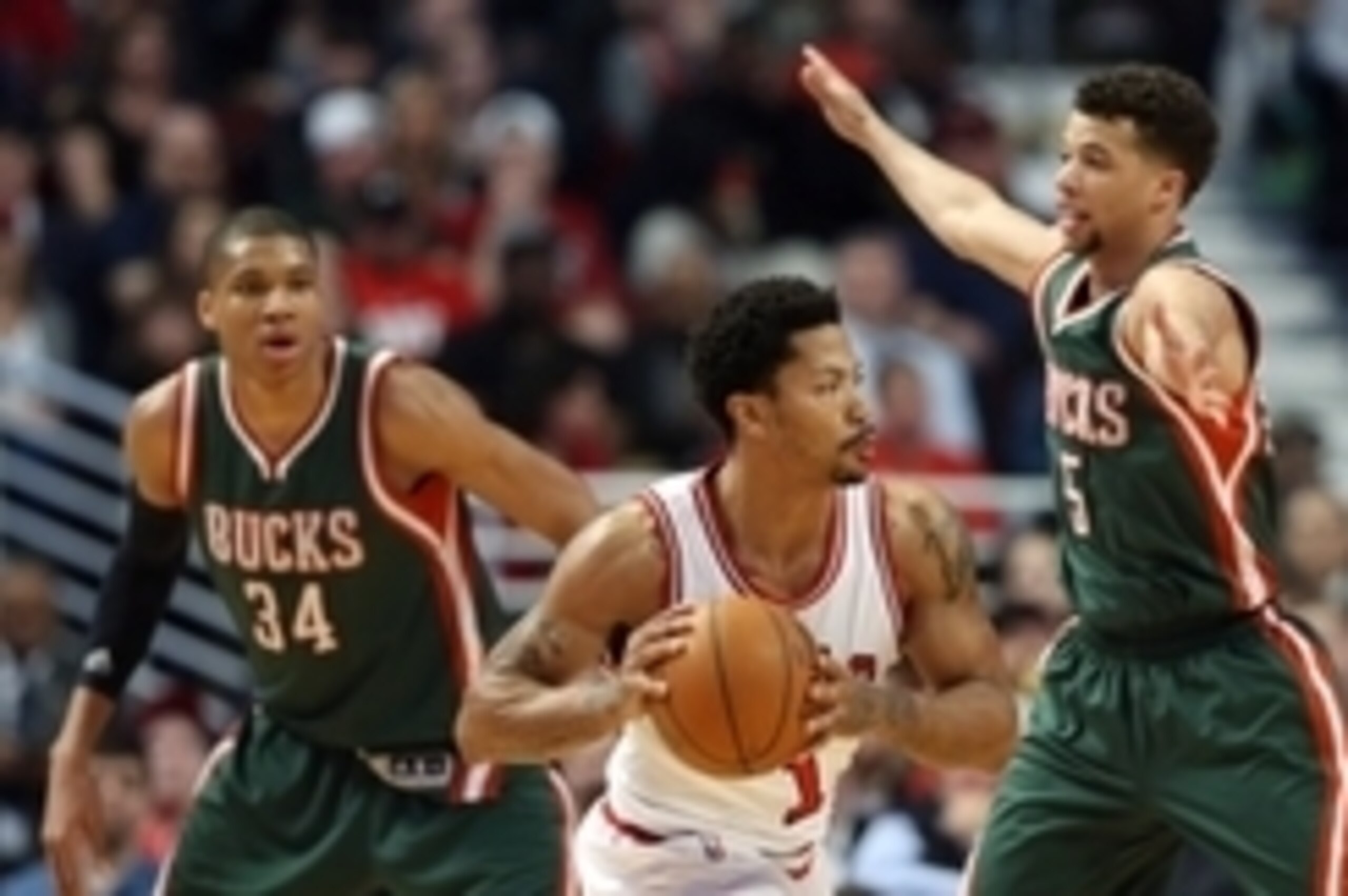Apr 18, 2015; Chicago, IL, USA; Chicago Bulls guard Derrick Rose (1) is defended by Milwaukee Bucks guard Michael Carter-Williams (5) and forward Giannis Antetokounmpo (34) during the second quarter in game one of the first round of the 2015 NBA Playoffs 