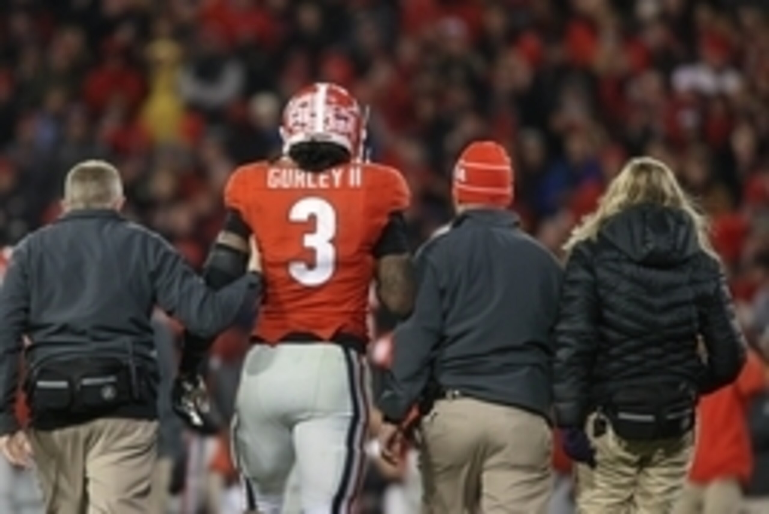 Nov 15, 2014; Athens, GA, USA; Georgia Bulldogs running back Todd Gurley (3) walks off of the field with training staff after getting a knee injury in the fourth quarter of their game against the Auburn Tigers at Sanford Stadium. Georgia won 34-7. Mandato Nov 15, 2014; Athens, GA, USA; Georgia Bulldogs running back Todd Gurley (3) walks off of the field with training staff after getting a knee injury in the fourth quarter of their game against the Auburn Tigers at Sanford Stadium. Georgia won 34-7. Mandato